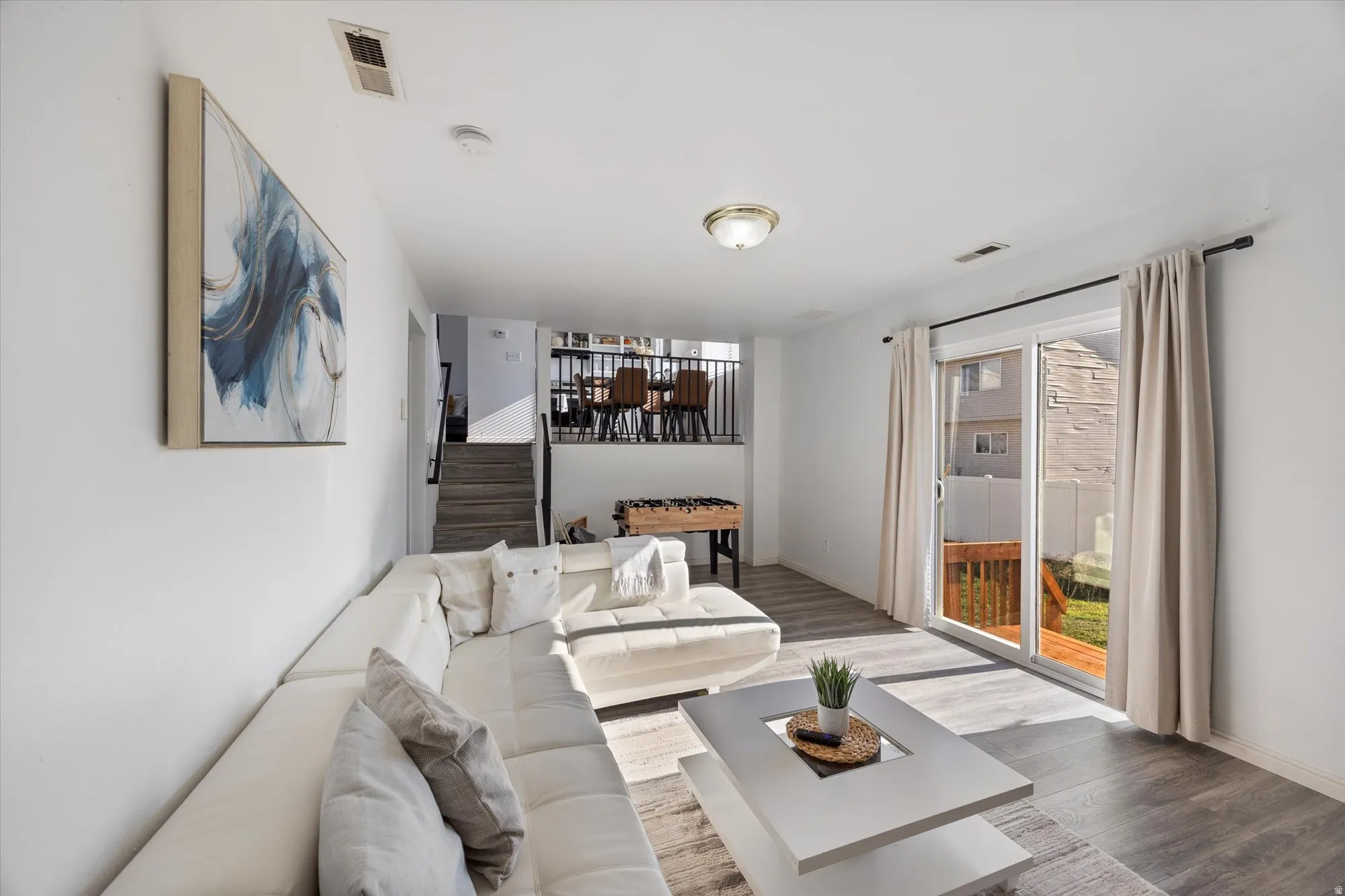 Living room featuring stairway and wood finished floors