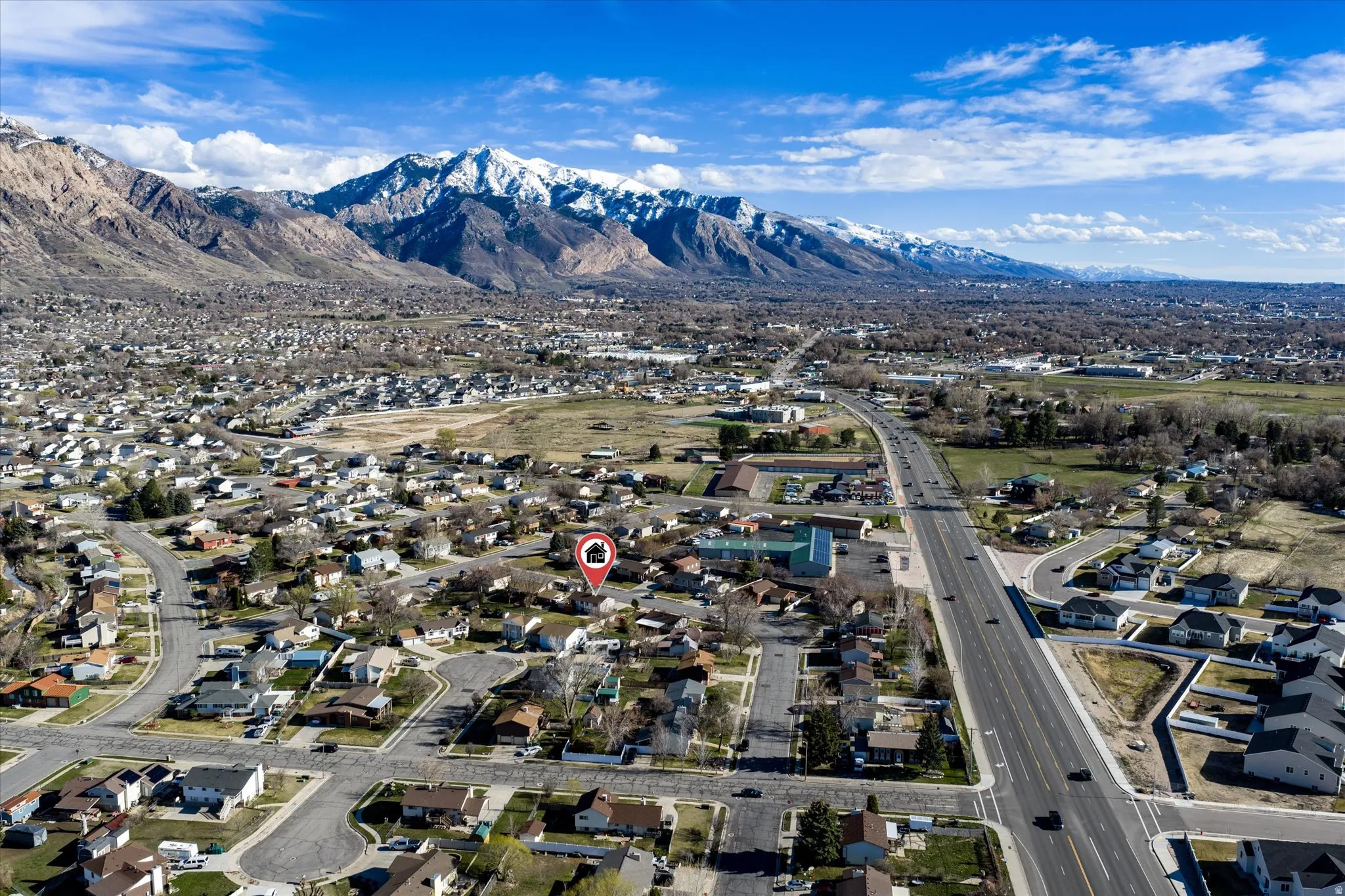 Aerial overview of property's location with nearby suburban area and mountains