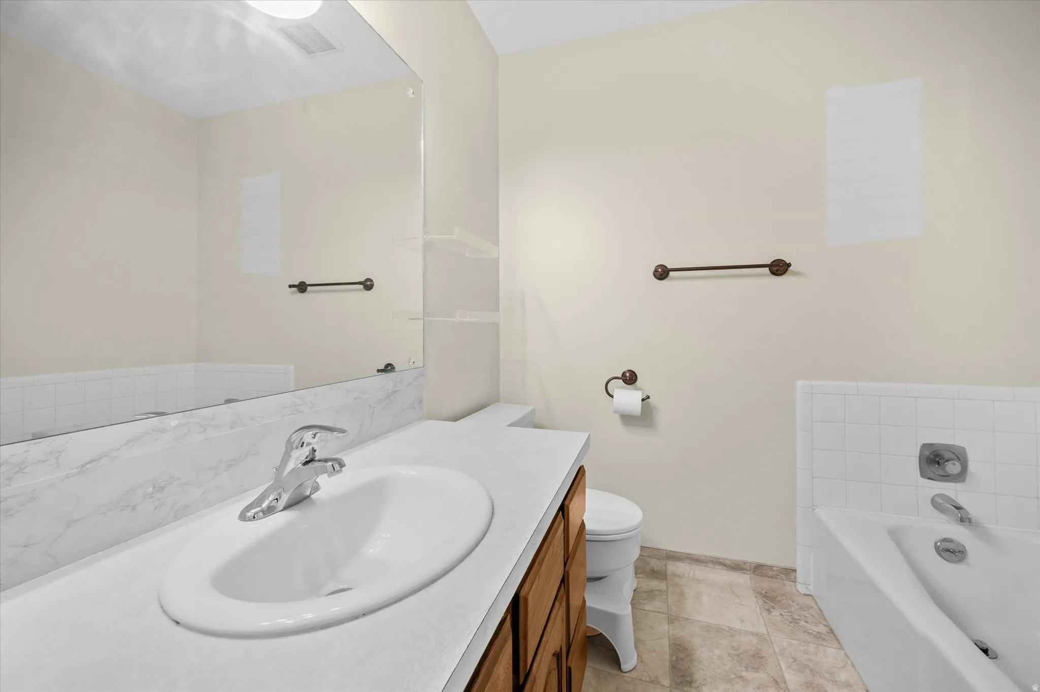 Full bathroom with vanity and a garden tub