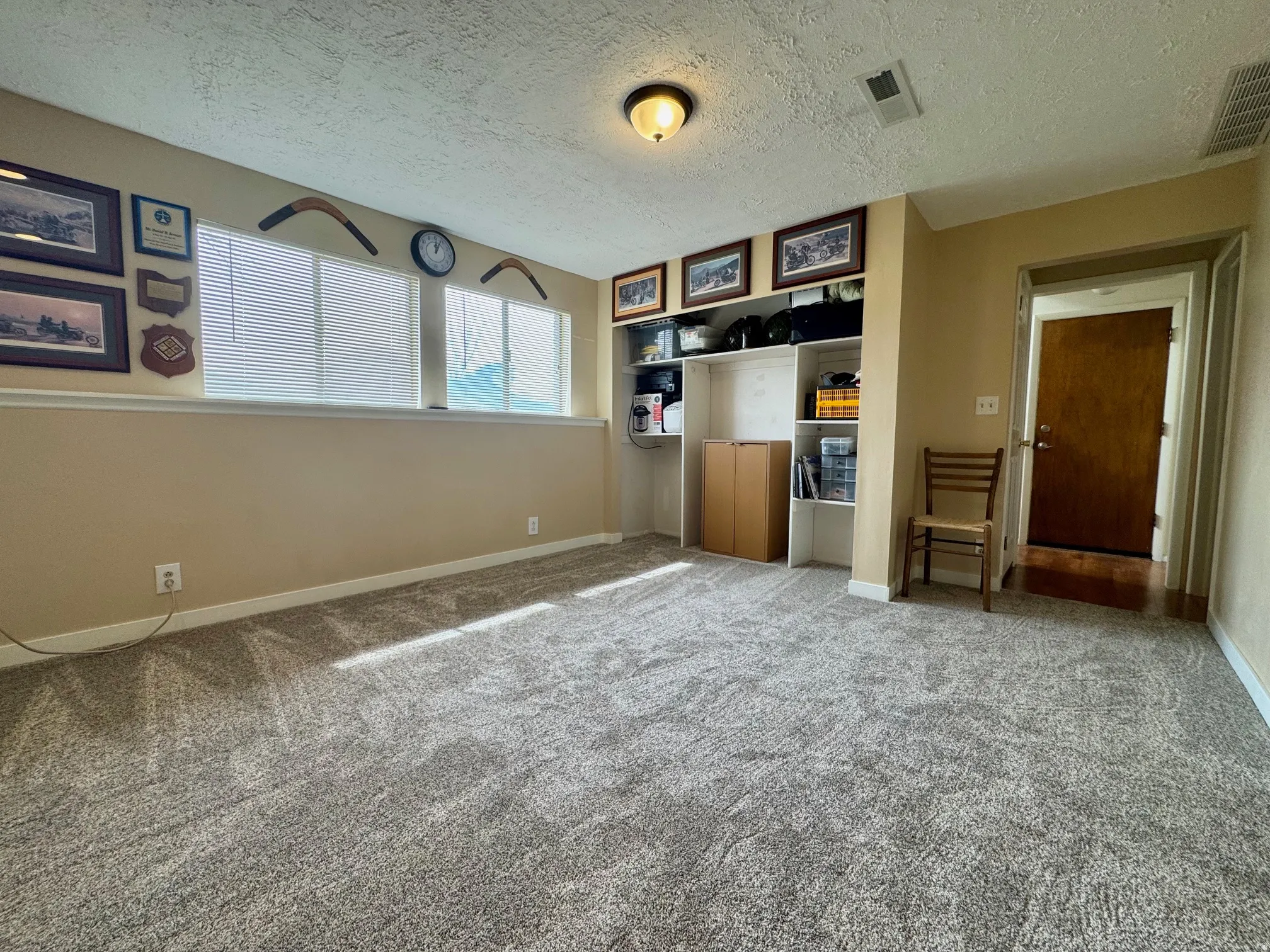 Unfurnished bedroom with a textured ceiling and carpet flooring