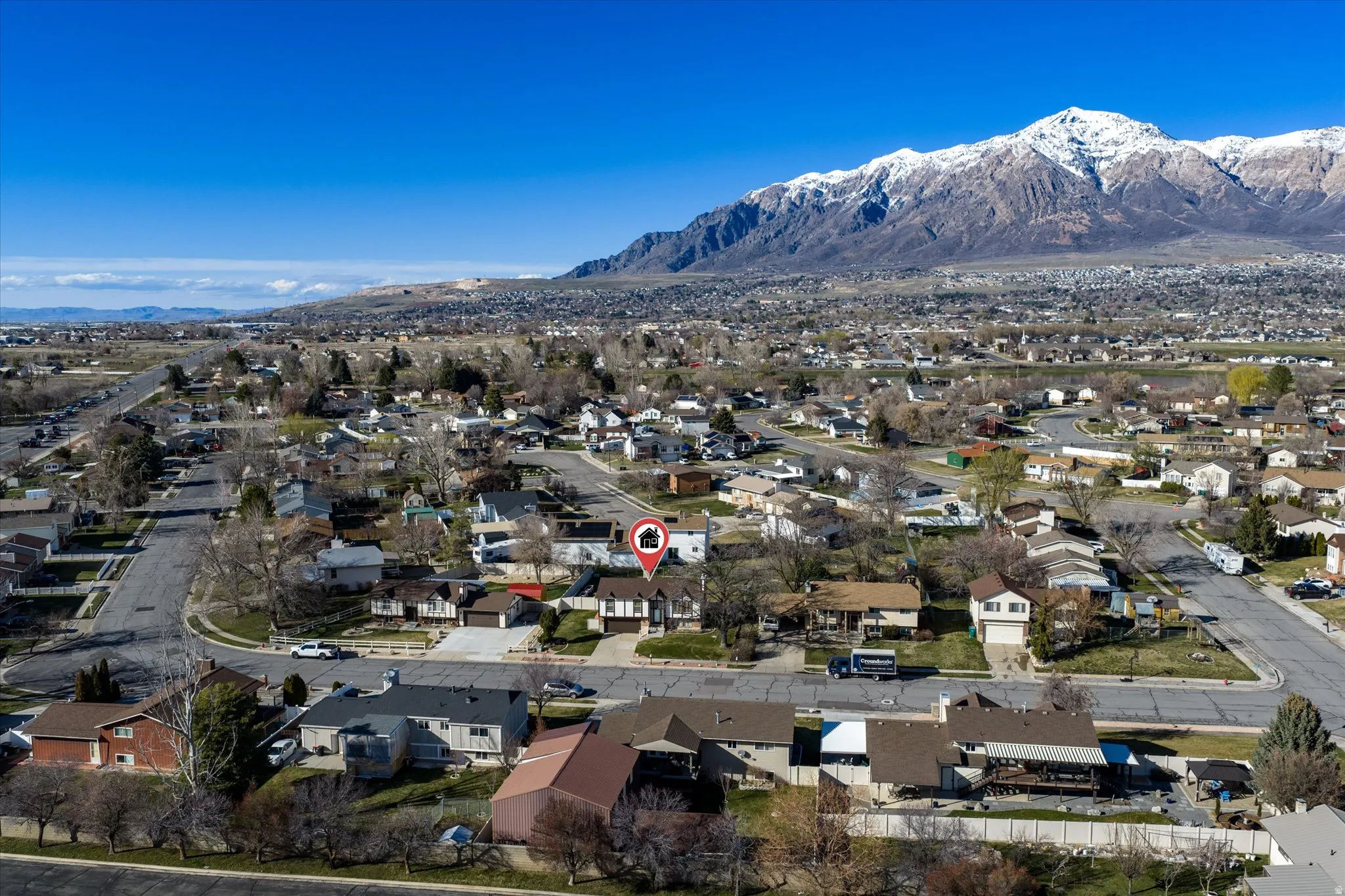 Aerial perspective of suburban area featuring a mountainous background