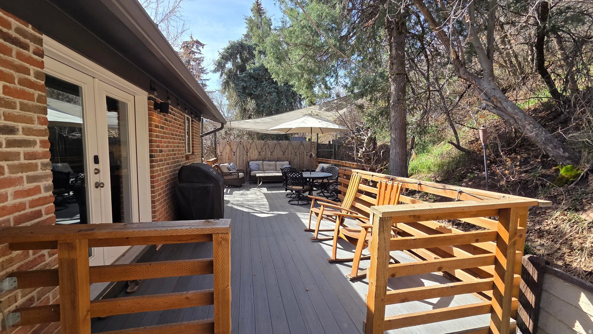 Wooden deck with french doors, outdoor lounge area, and area for grilling