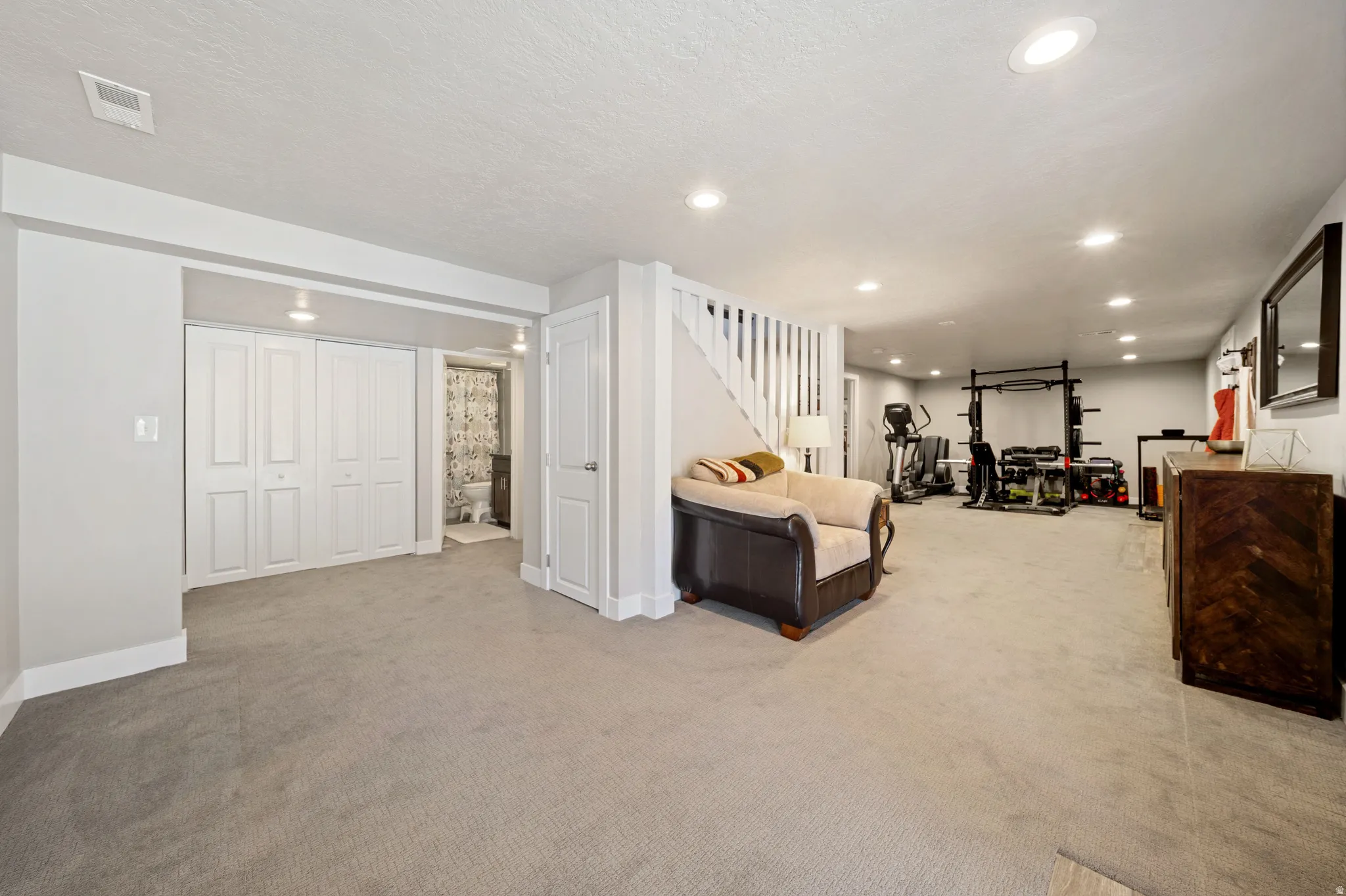 Living area featuring light carpet and recessed lighting
