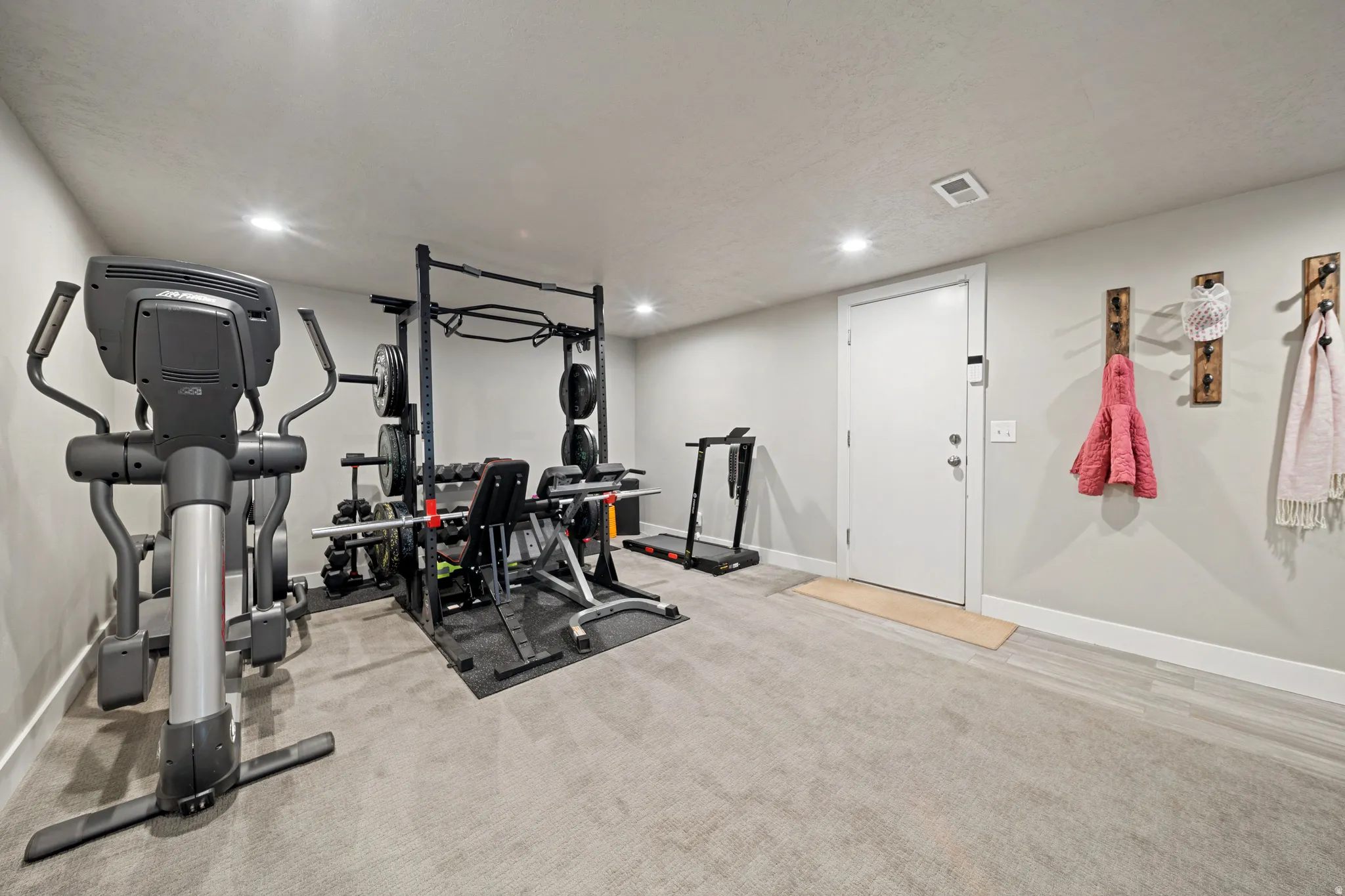 Workout area featuring light colored carpet and recessed lighting