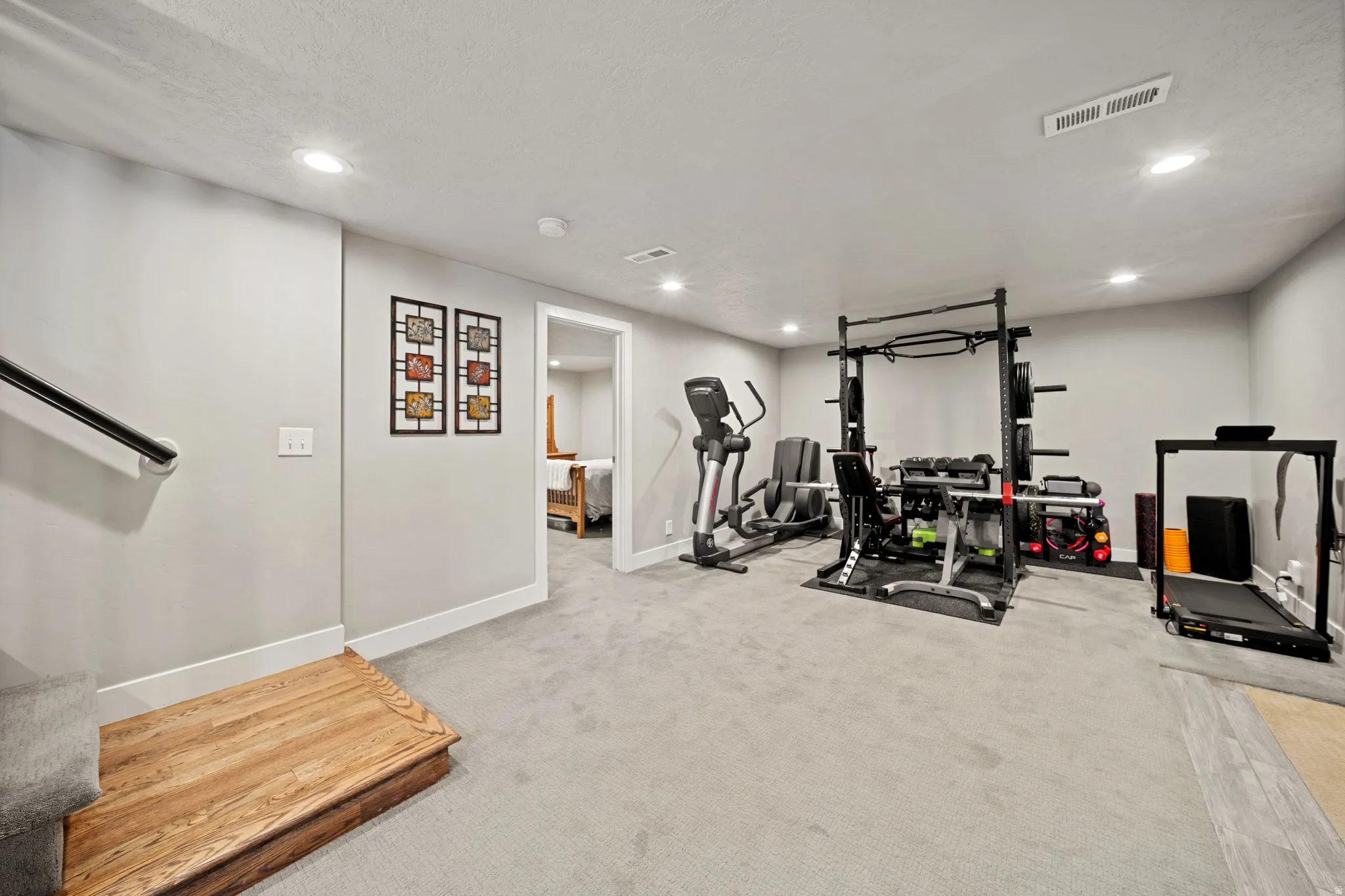 Workout area with light colored carpet and recessed lighting