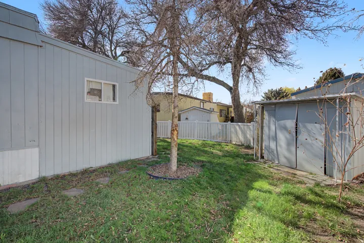 Fenced yard featuring a shed