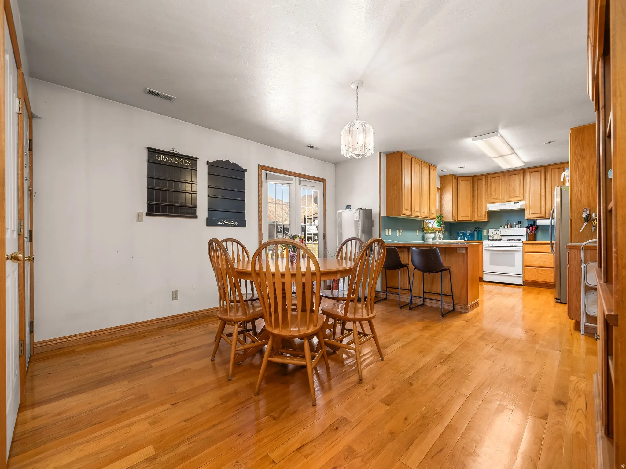 Dining room featuring hanging lights and light wood finished floors