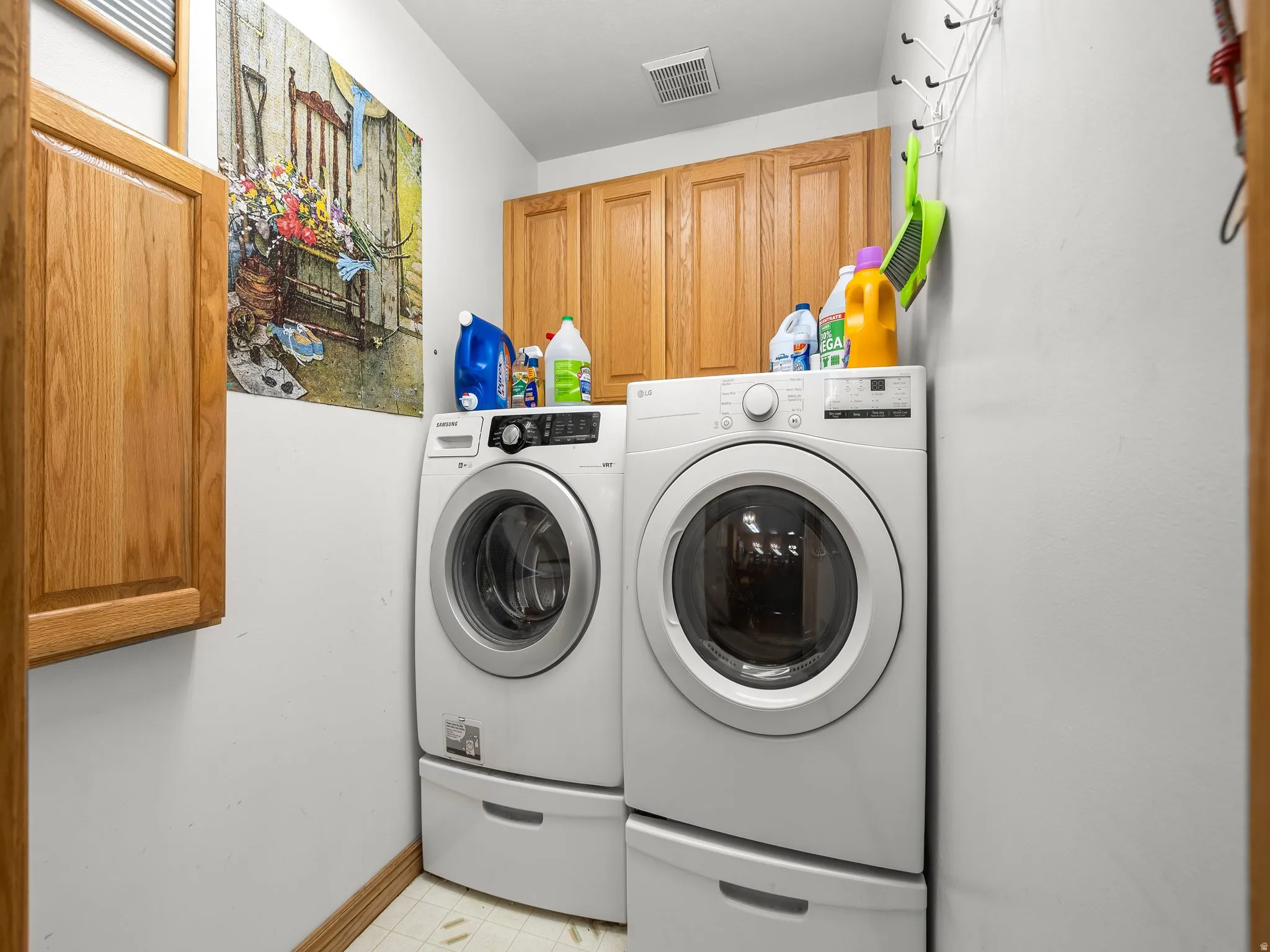 Laundry area with cabinet space and washer and clothes dryer