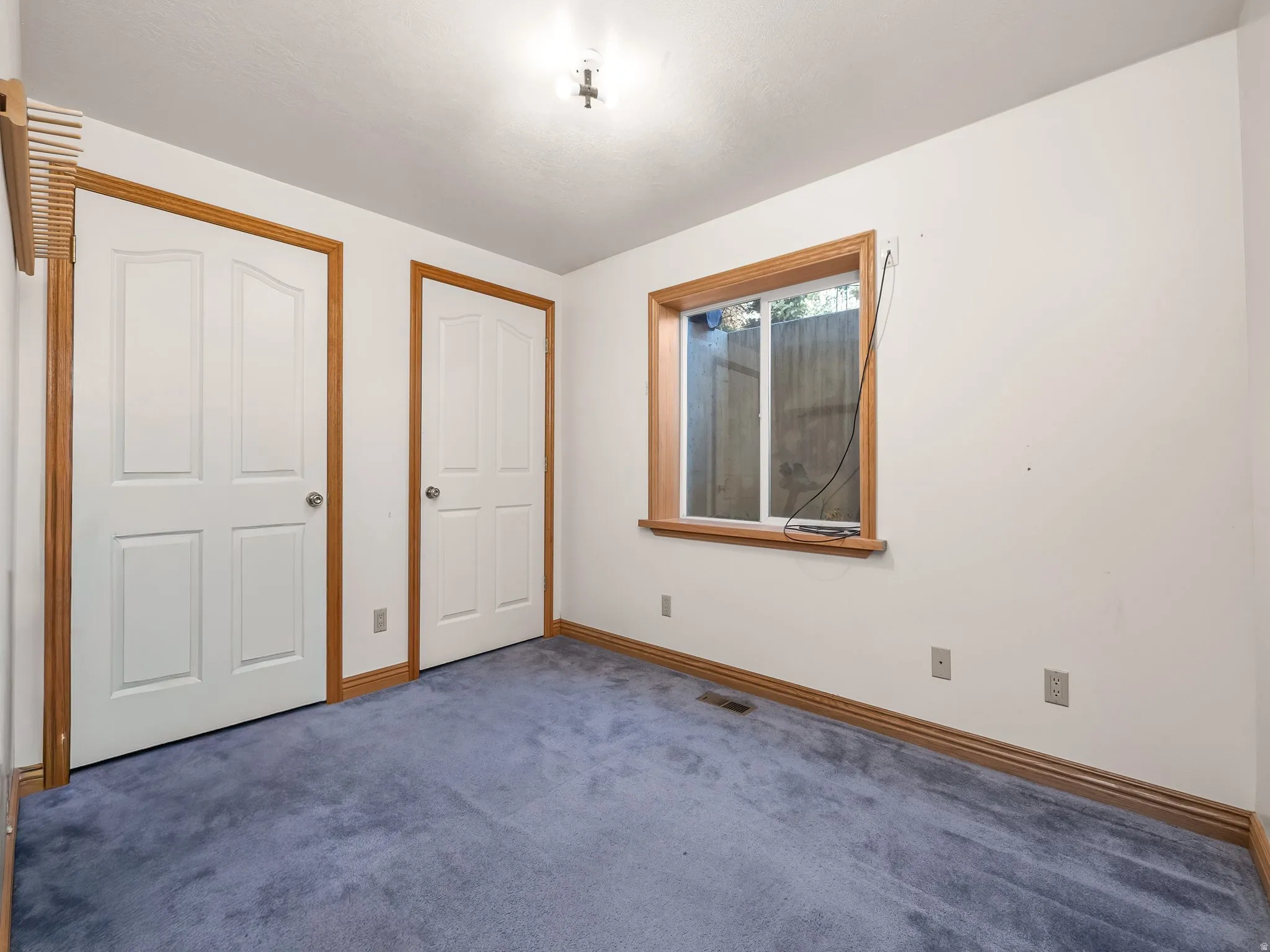 Unfurnished bedroom featuring carpet floors and baseboards