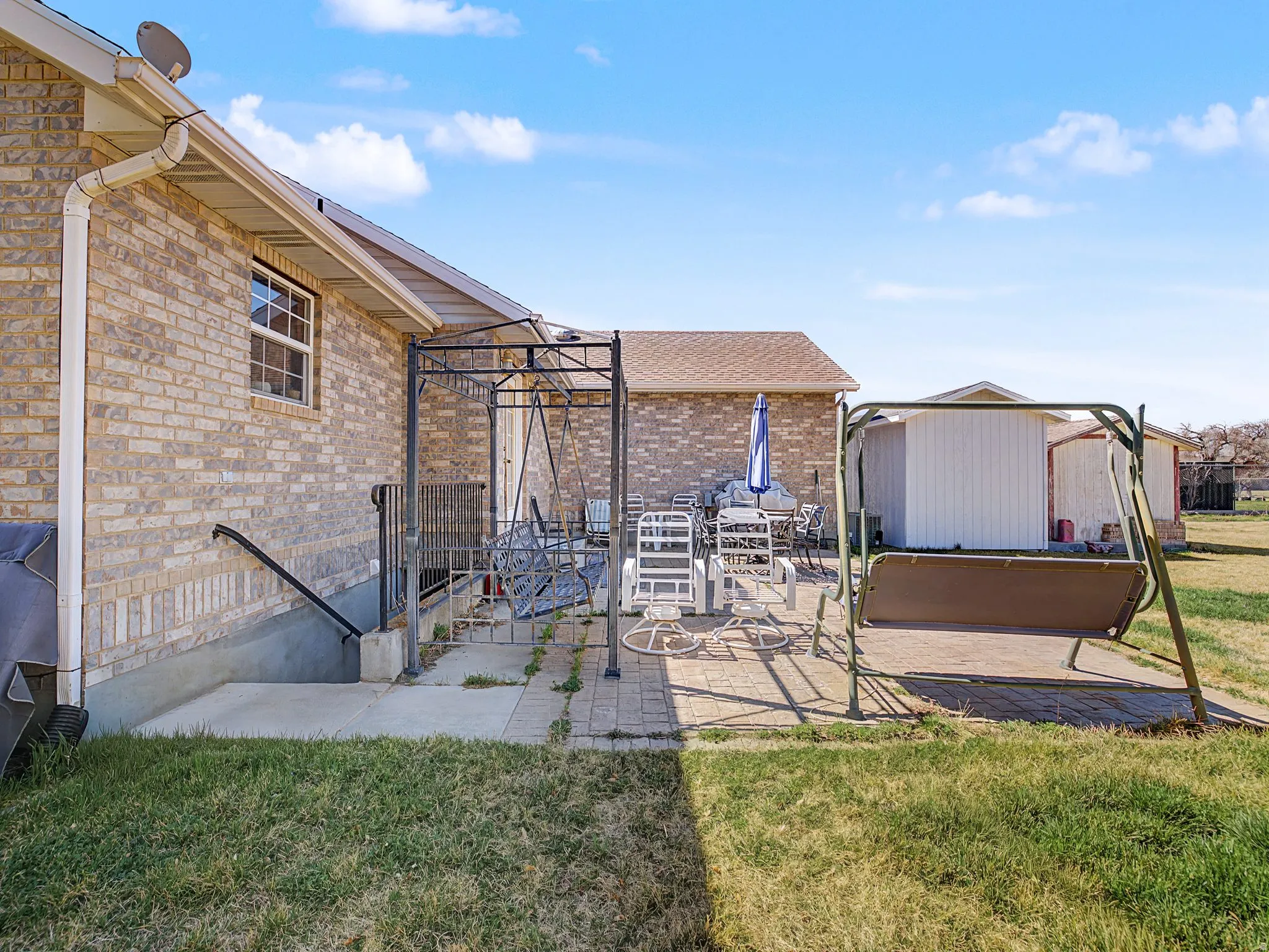 View of patio featuring a shed