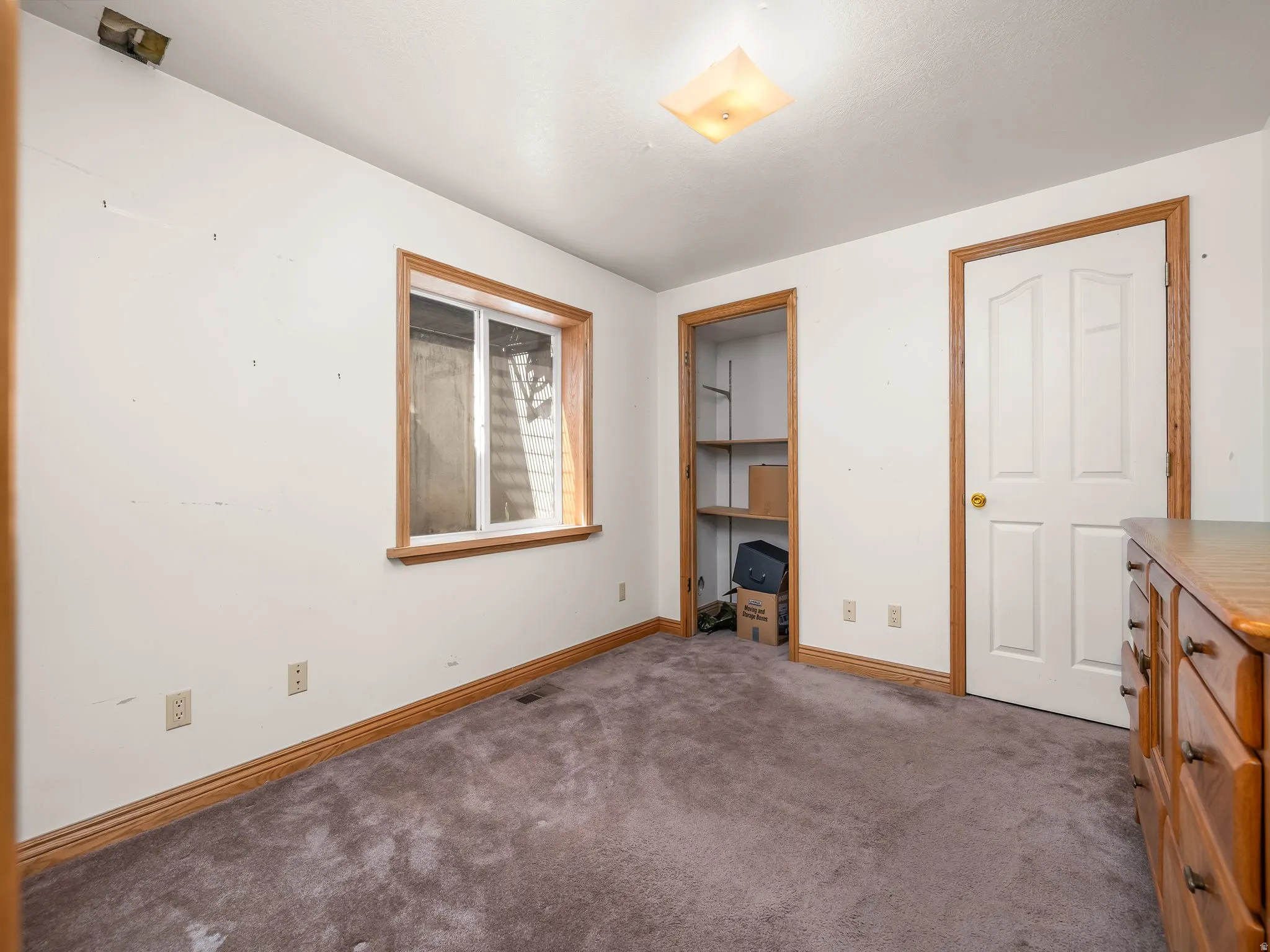 Unfurnished bedroom featuring carpet and baseboards