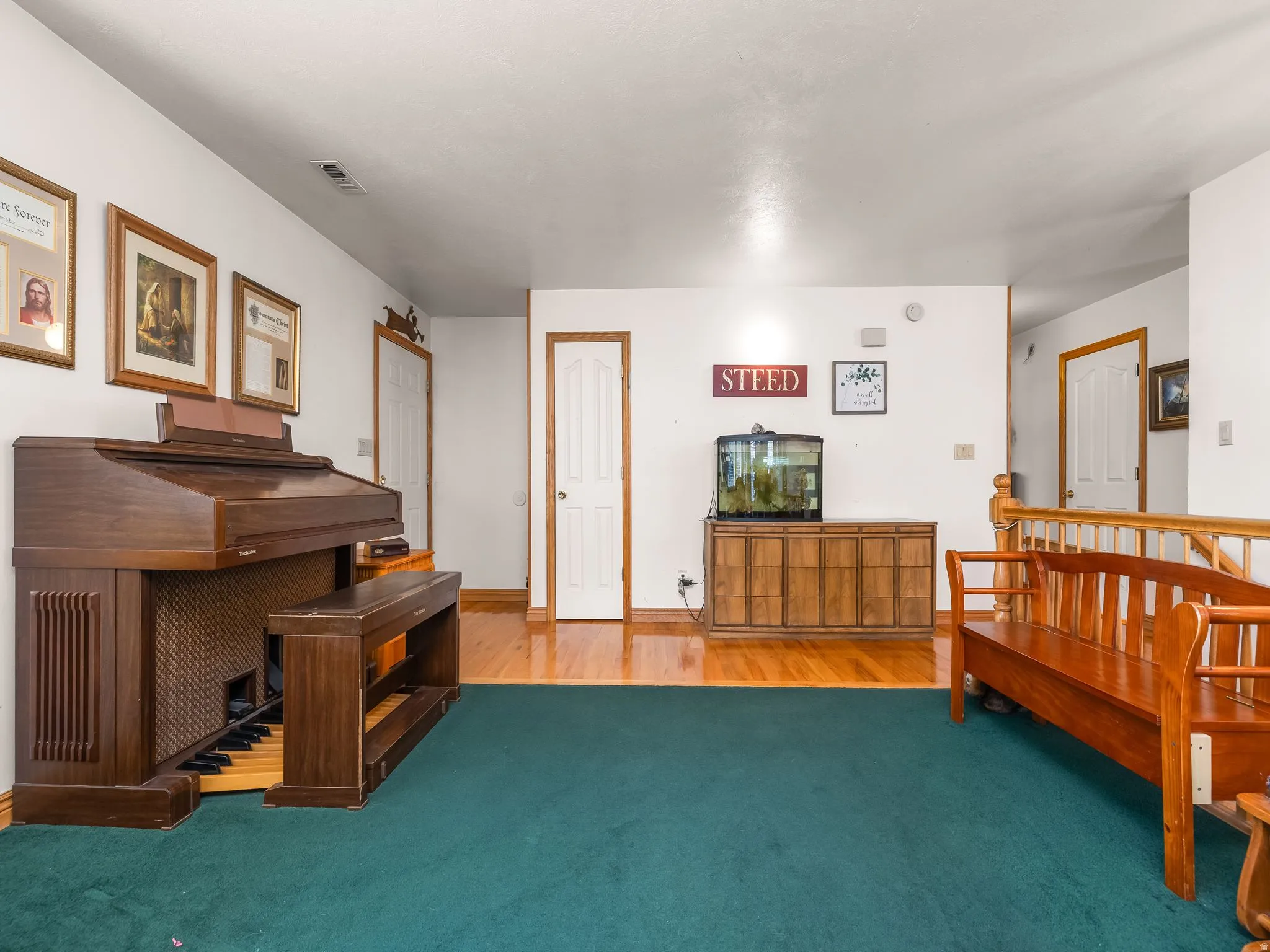 Living room with light wood-style floors, carpet, and baseboards