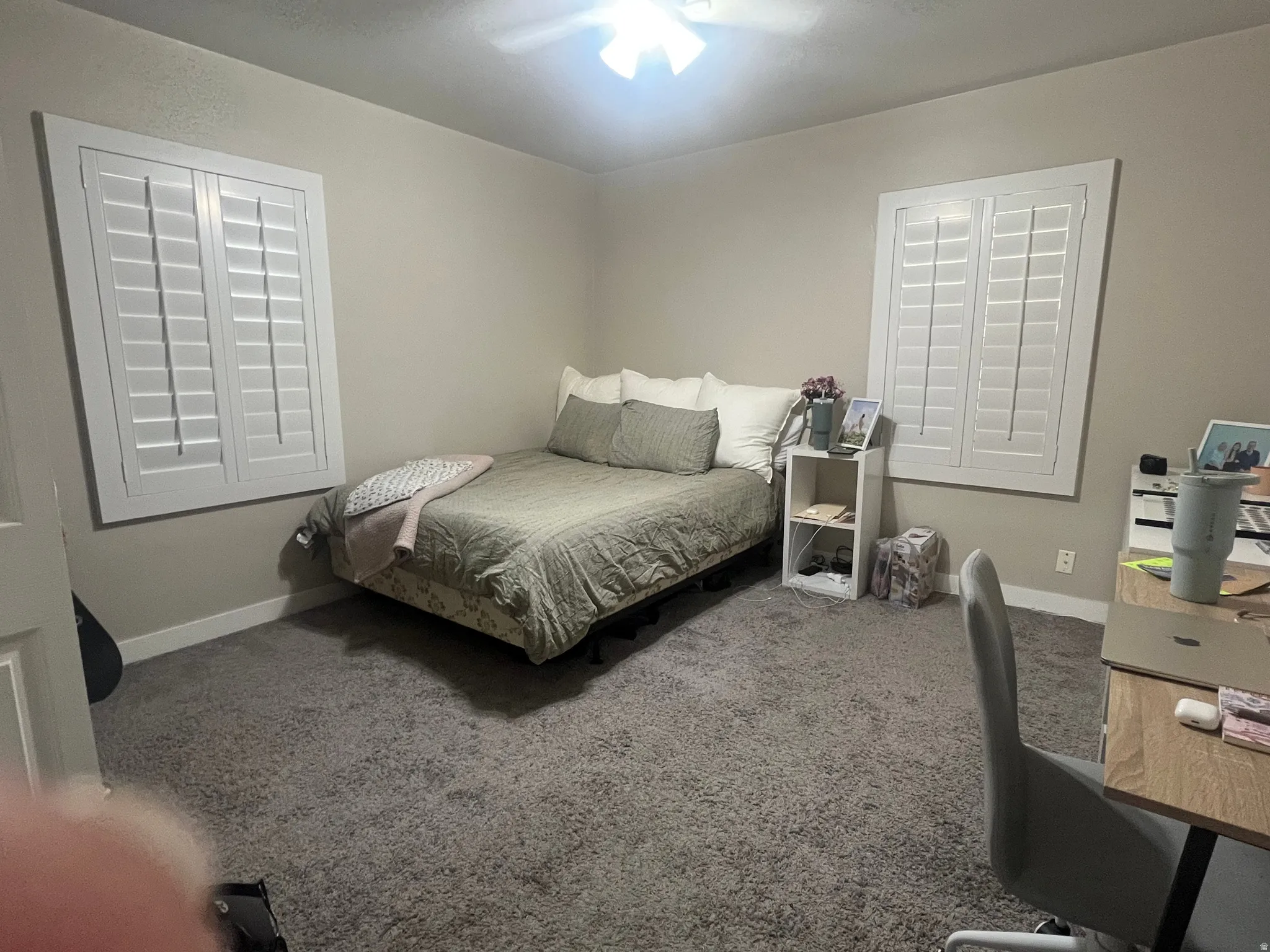 Bedroom featuring carpet, a ceiling fan, and an office area