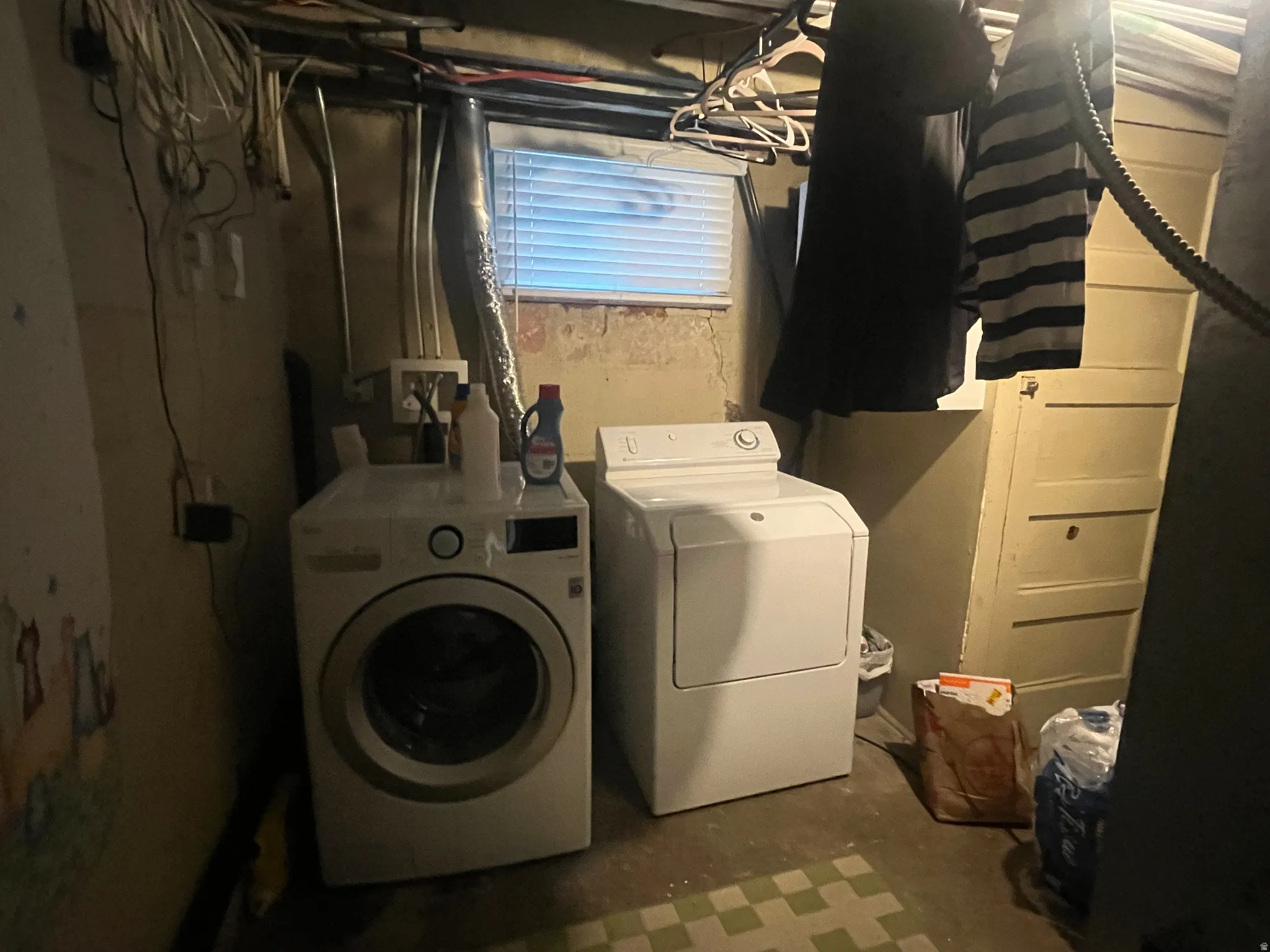 Laundry area featuring concrete floors and washer and dryer