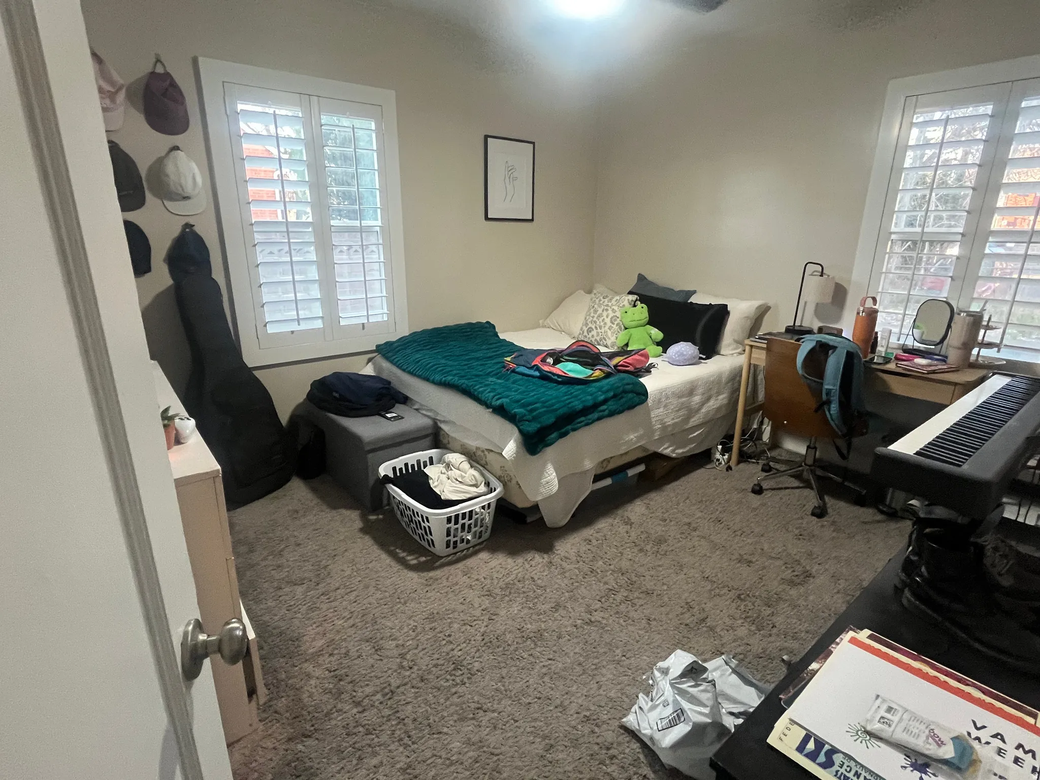 Bedroom with carpet flooring and an office area