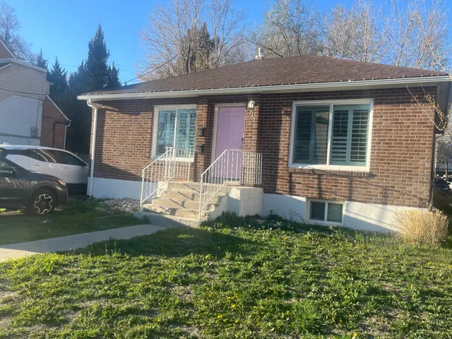 View of front of property with a front lawn and brick siding