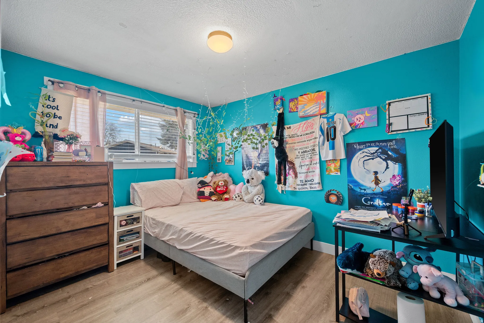 Bedroom featuring wood finished floors and a textured ceiling
