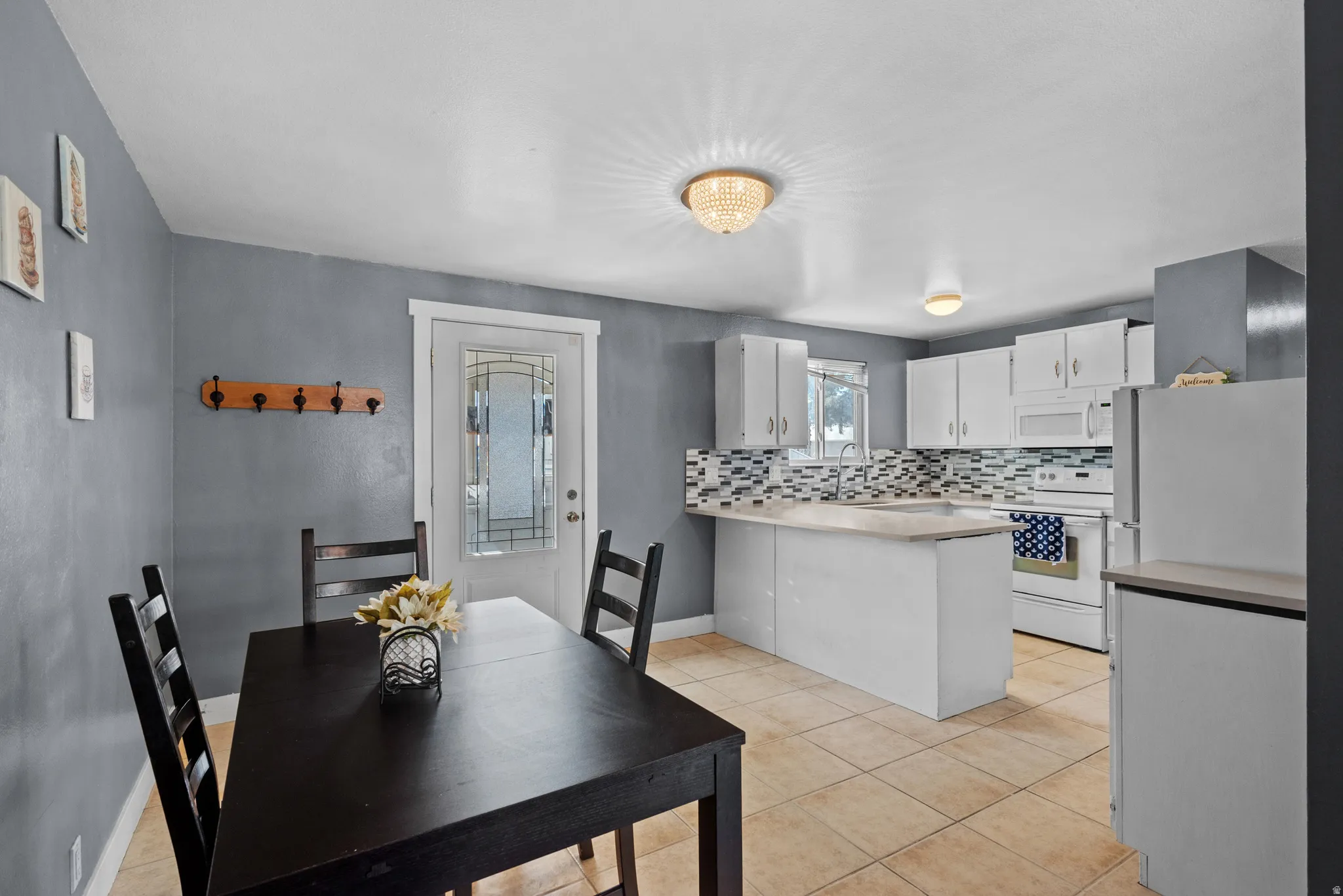 Dining room featuring light tile patterned floors and baseboards