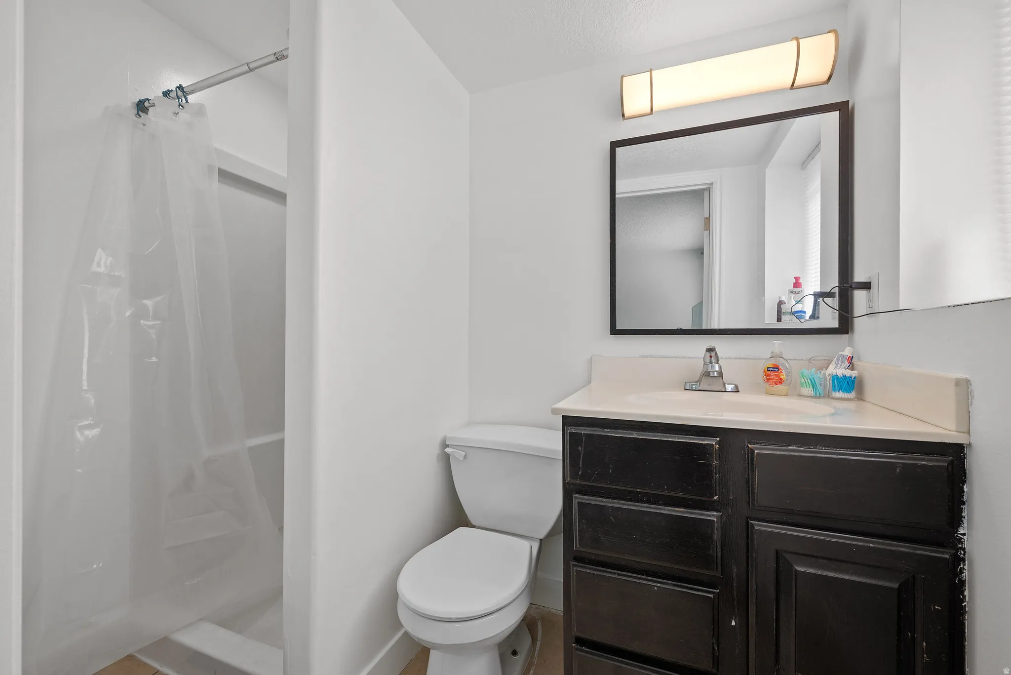 Full bathroom with vanity and a shower stall