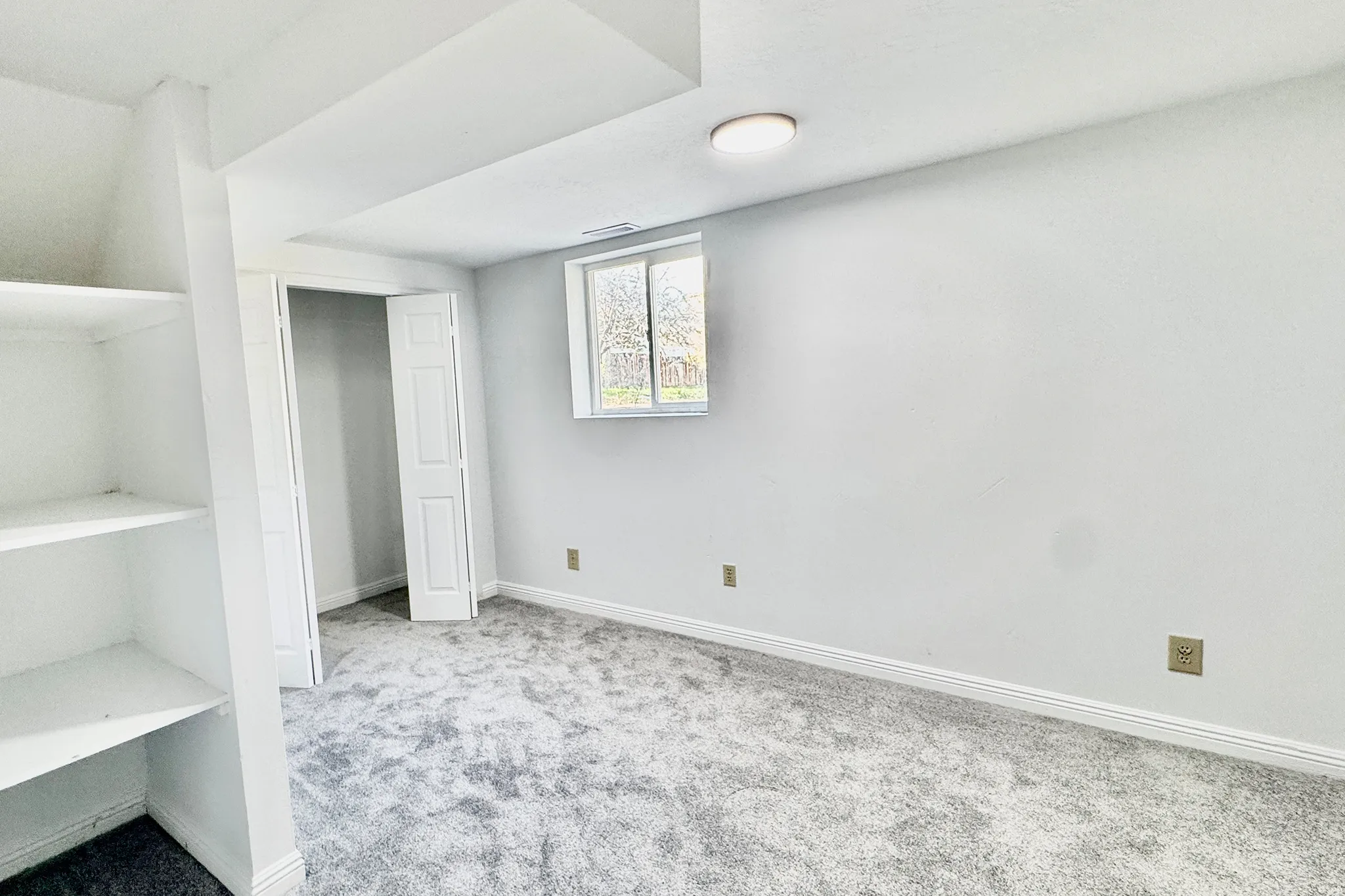 Unfurnished bedroom featuring light colored carpet and a closet