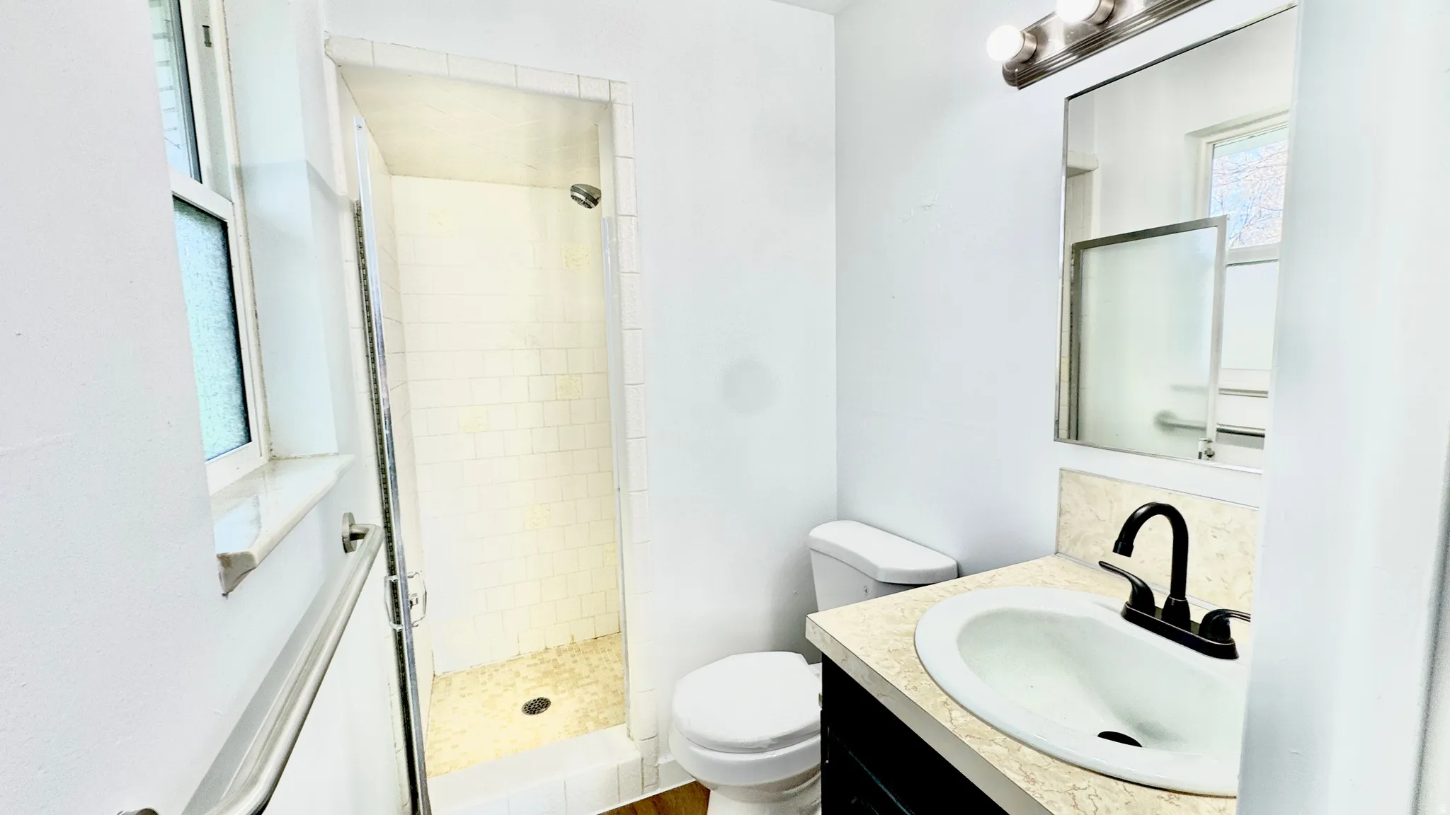 Full bath with vanity and a stall shower