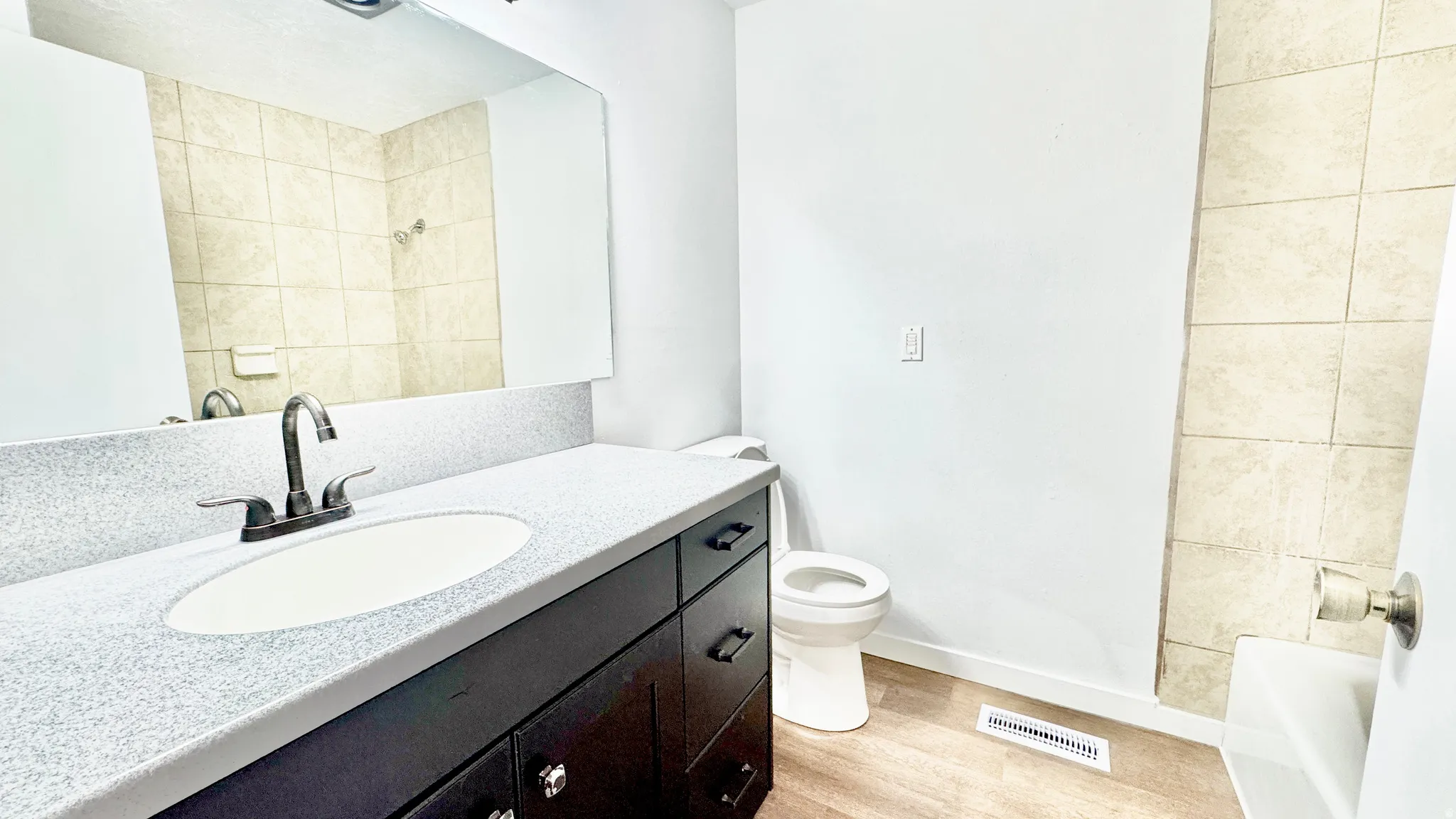 Full bathroom with vanity and light wood-style floors