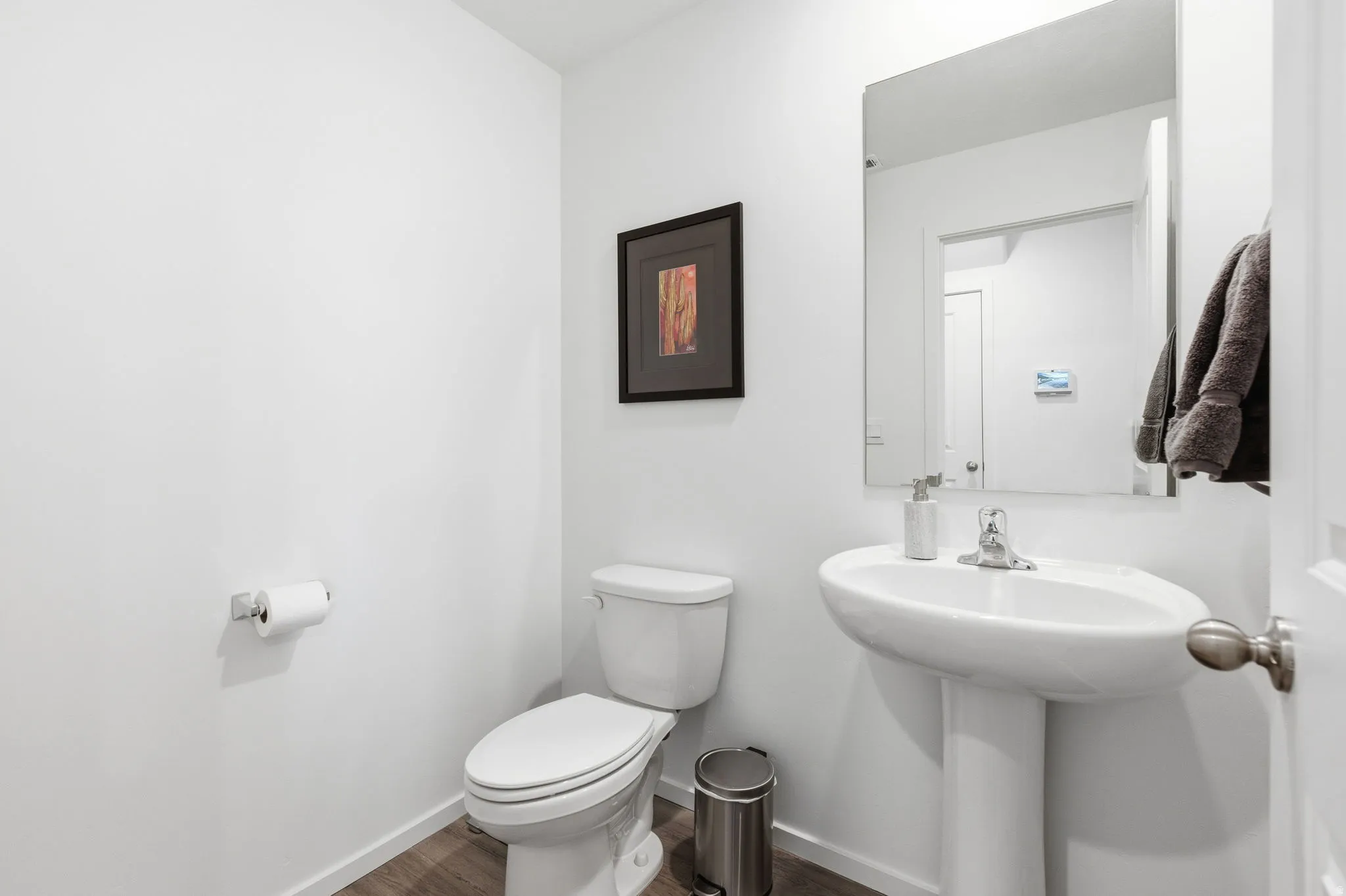 Bathroom with toilet and dark wood-style floors