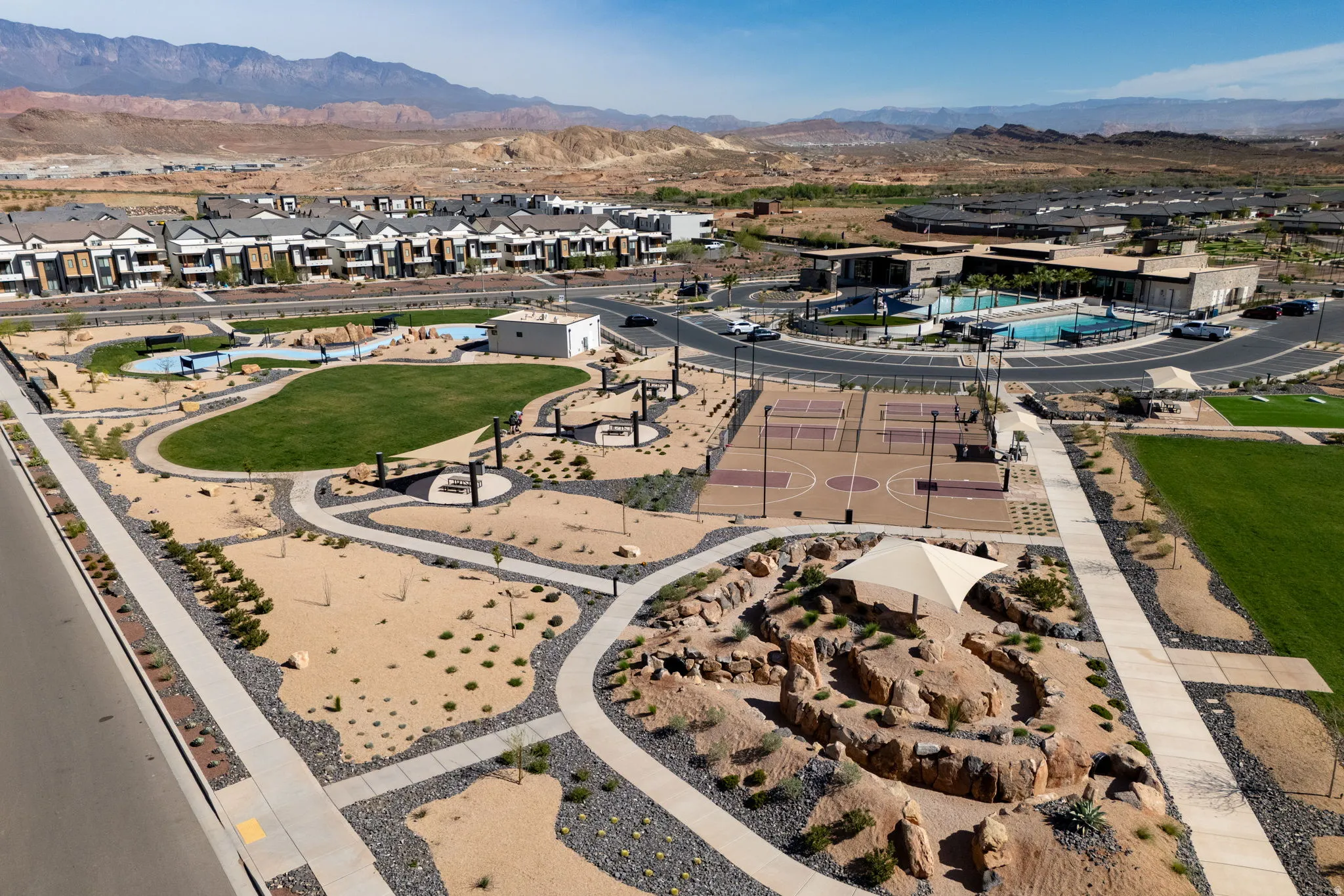 Aerial view of property's location with a mountain backdrop and nearby suburban area