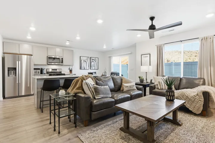 Living room featuring healthy amount of natural light, light wood-type flooring, recessed lighting, and a ceiling fan
