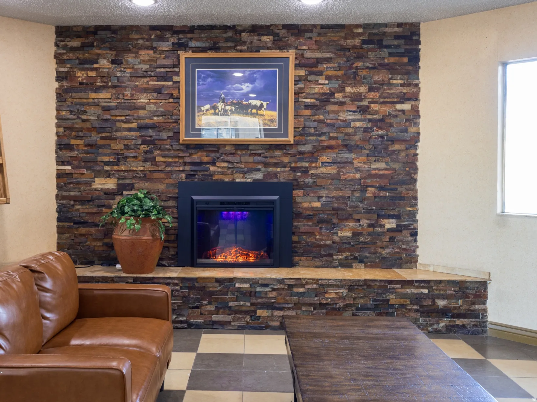 Living room with a textured ceiling, a fireplace, and recessed lighting