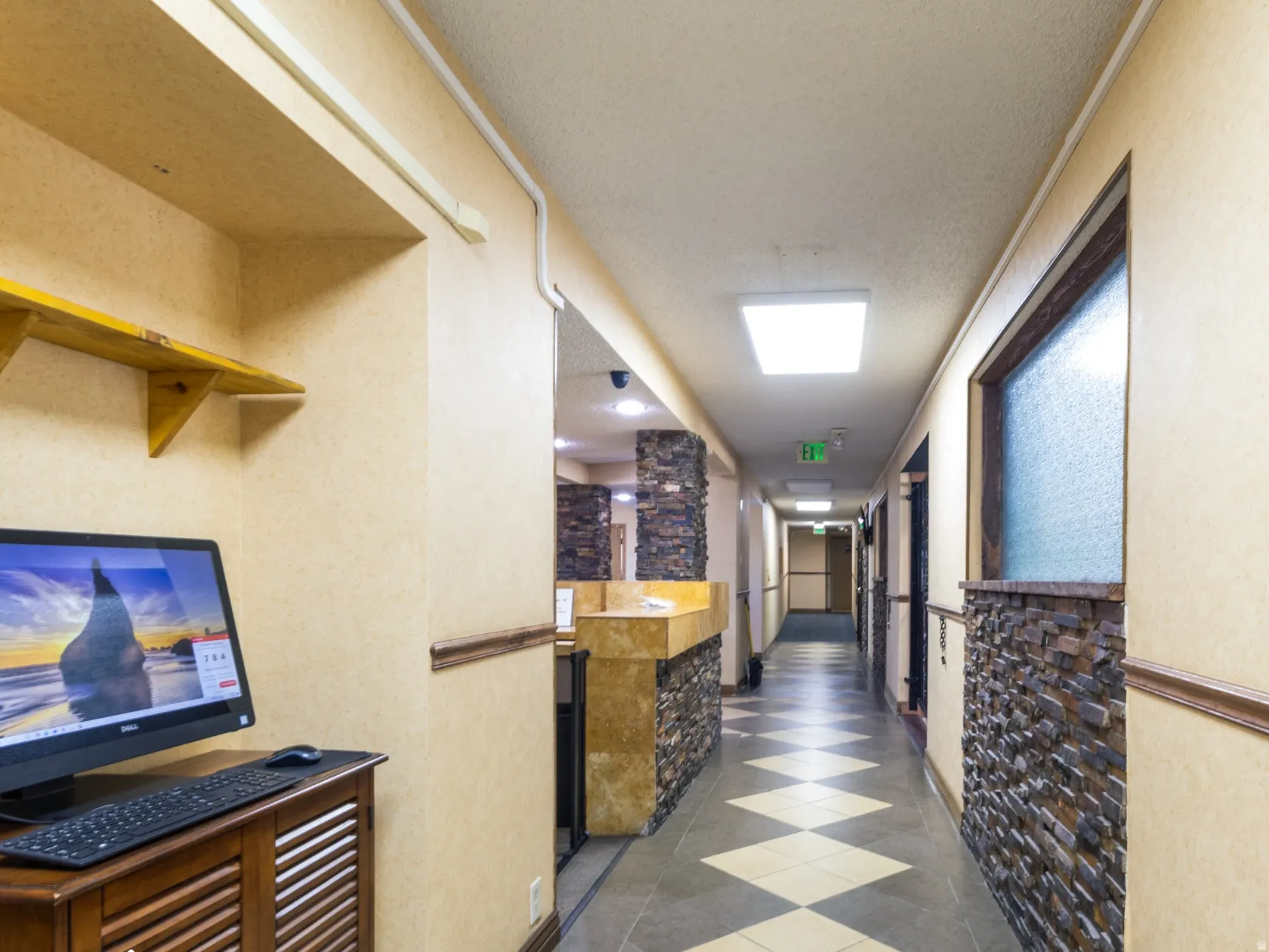 Corridor with baseboards and tile patterned floors