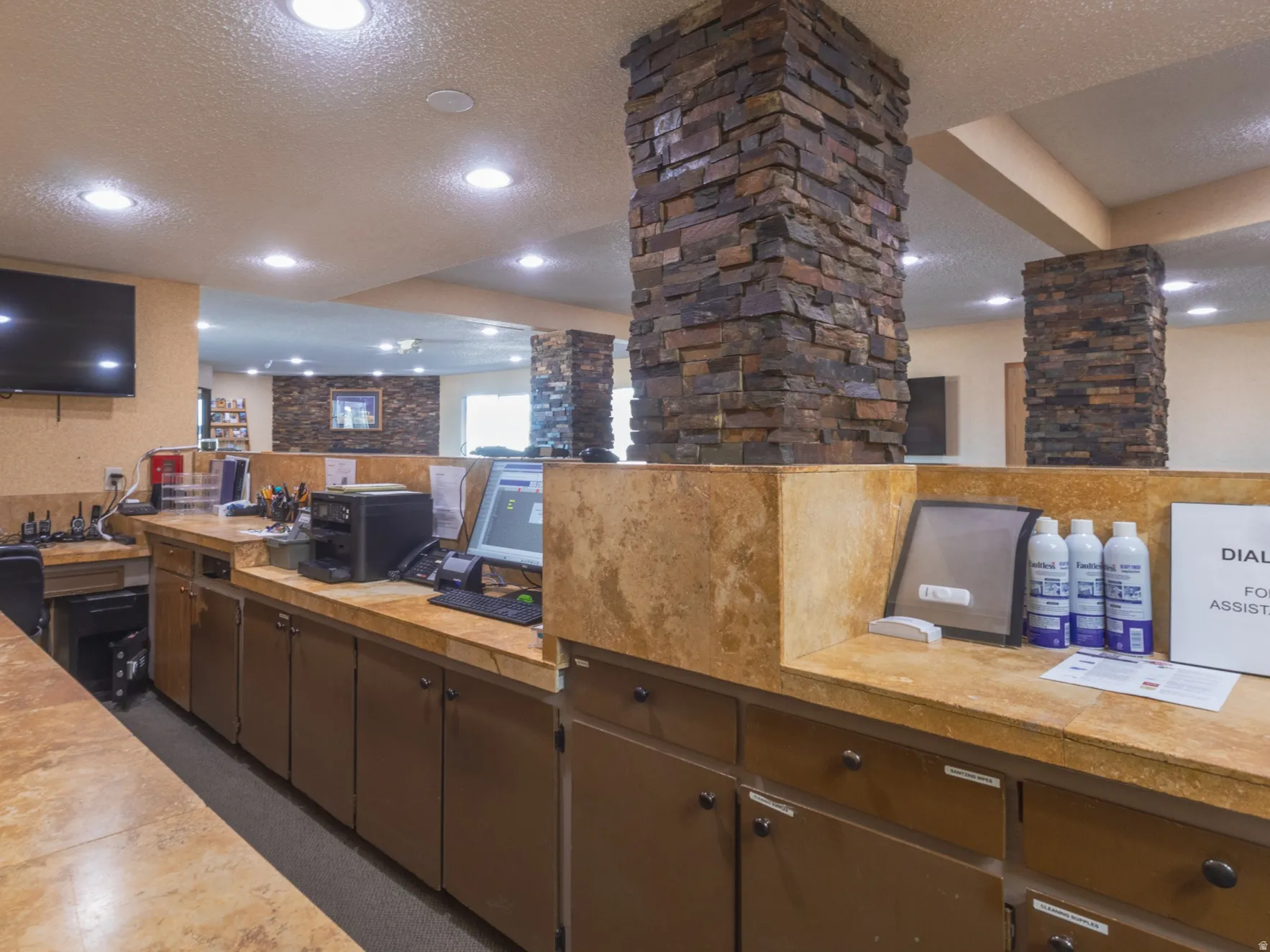 Kitchen featuring a textured ceiling, butcher block countertops, and recessed lighting