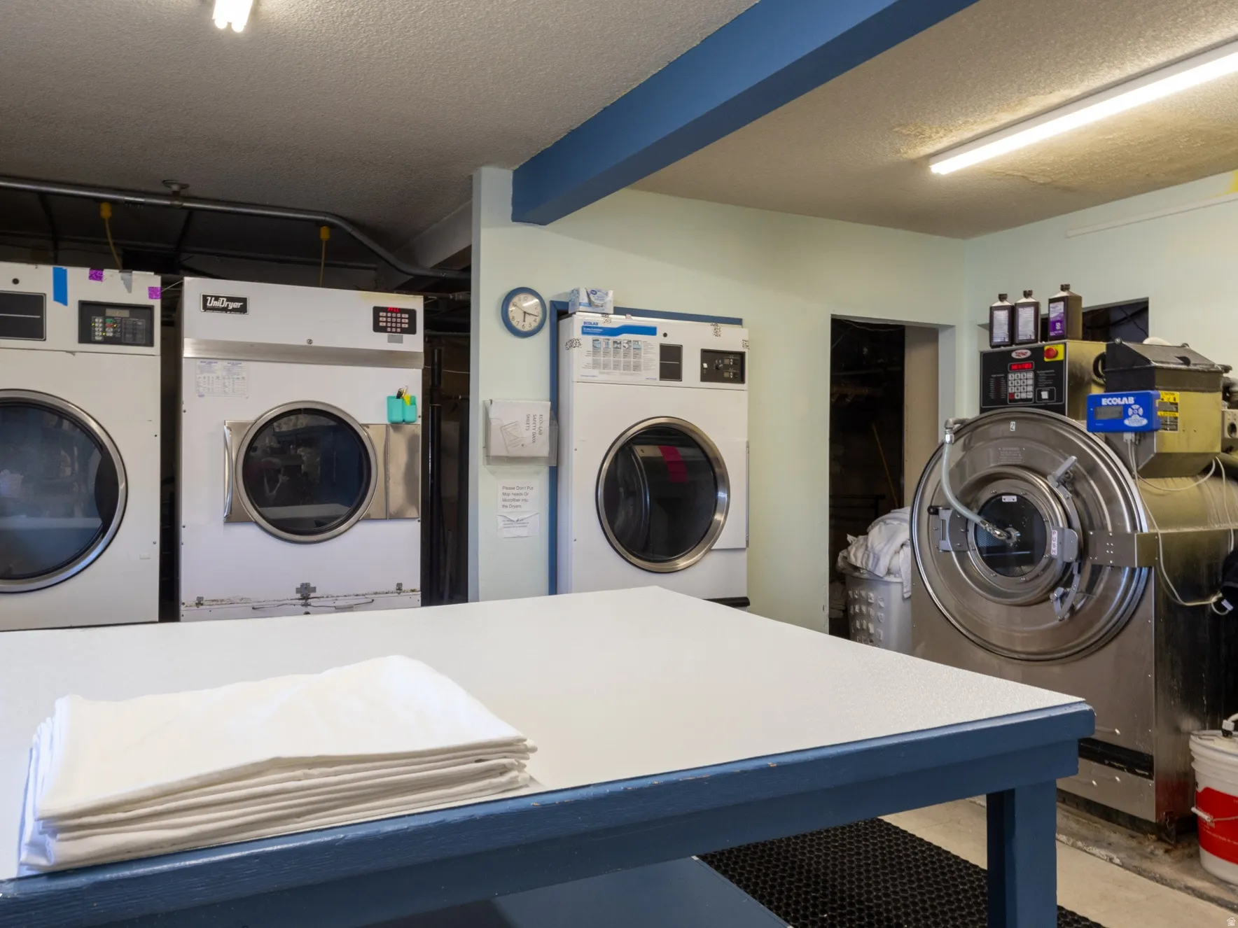 Shared laundry with a textured ceiling