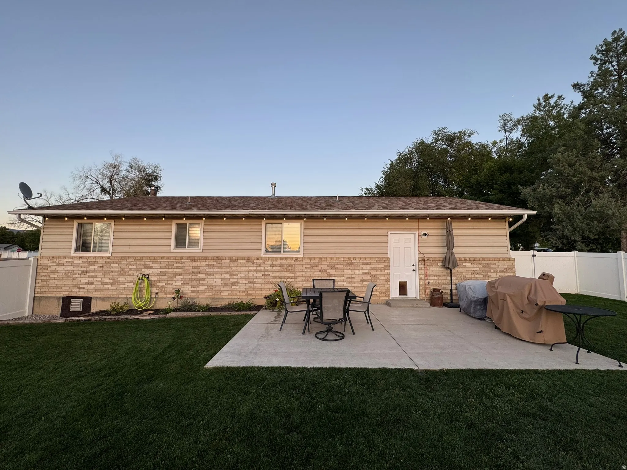 Back of house with a patio area and brick siding