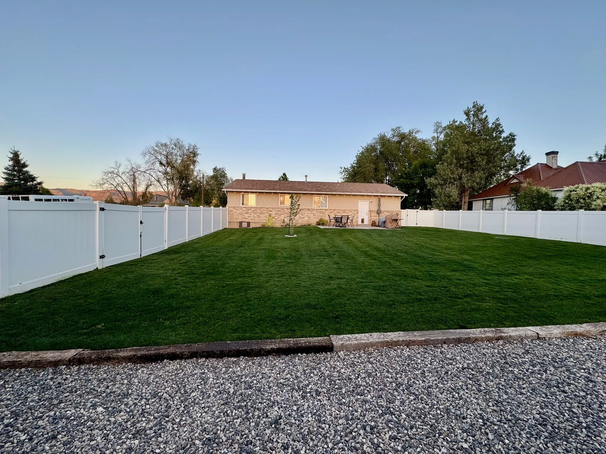 Back of property with a fenced backyard