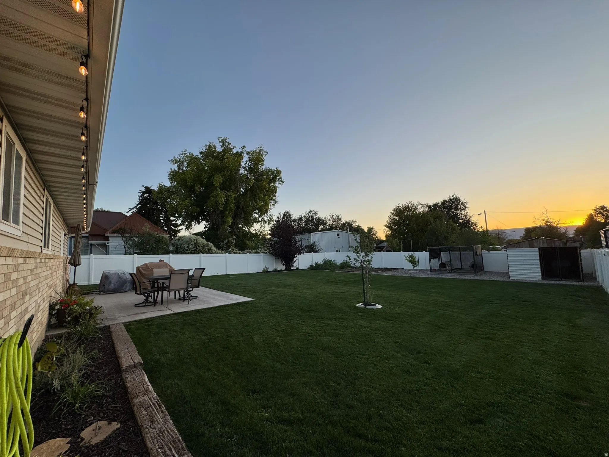 Fenced backyard with a patio
