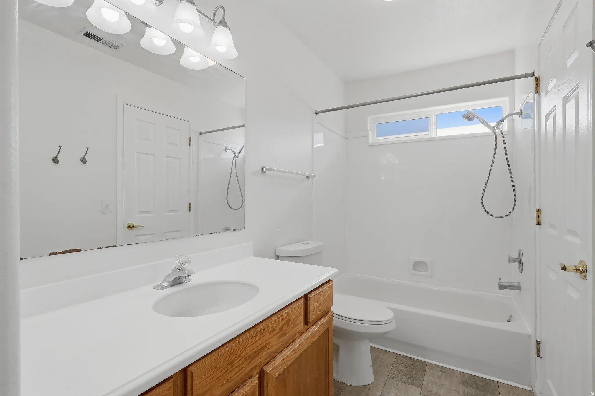 Full bath with vanity, shower / washtub combination, and light wood-type flooring