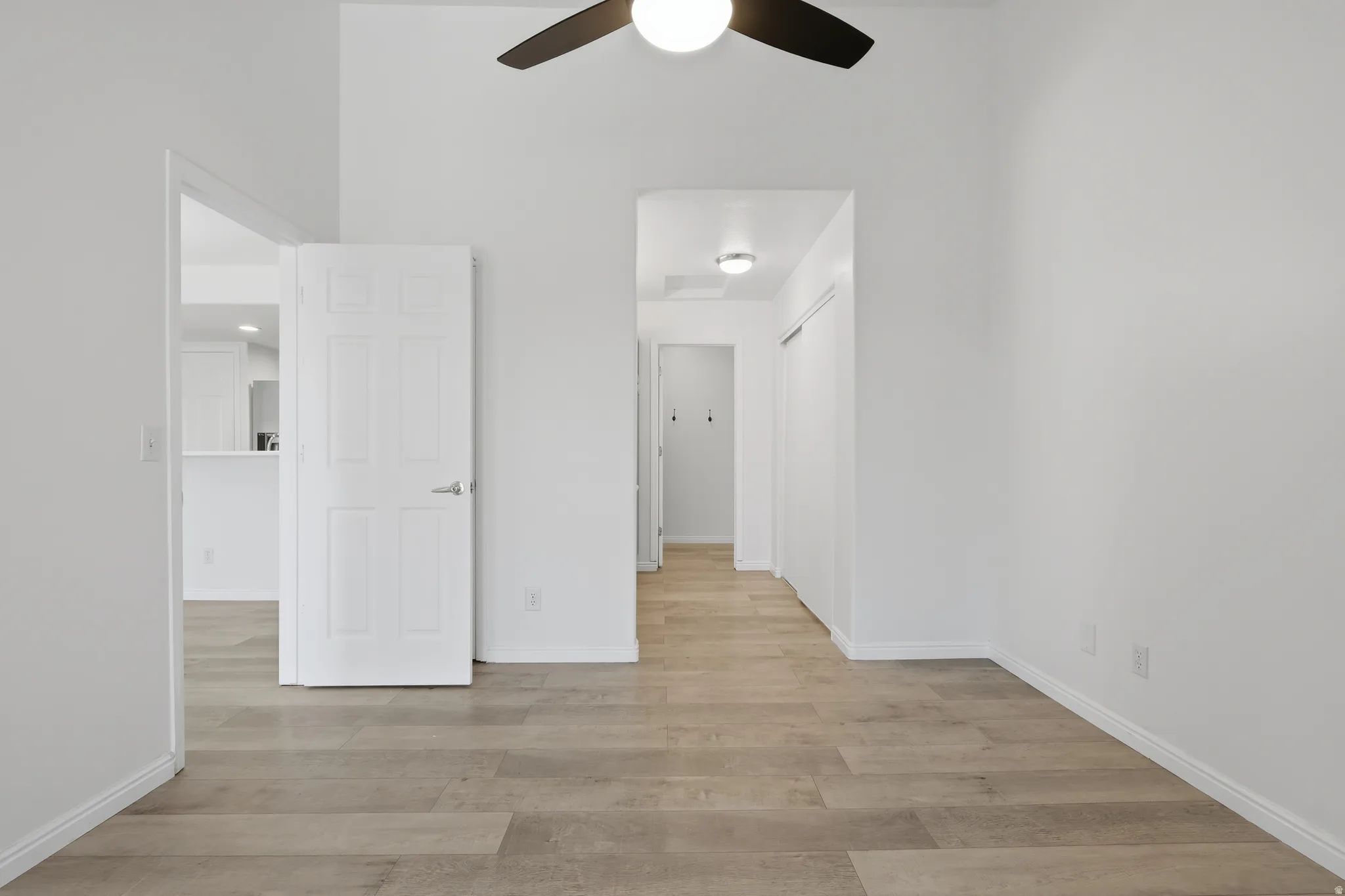 Unfurnished bedroom featuring light wood-type flooring and ceiling fan