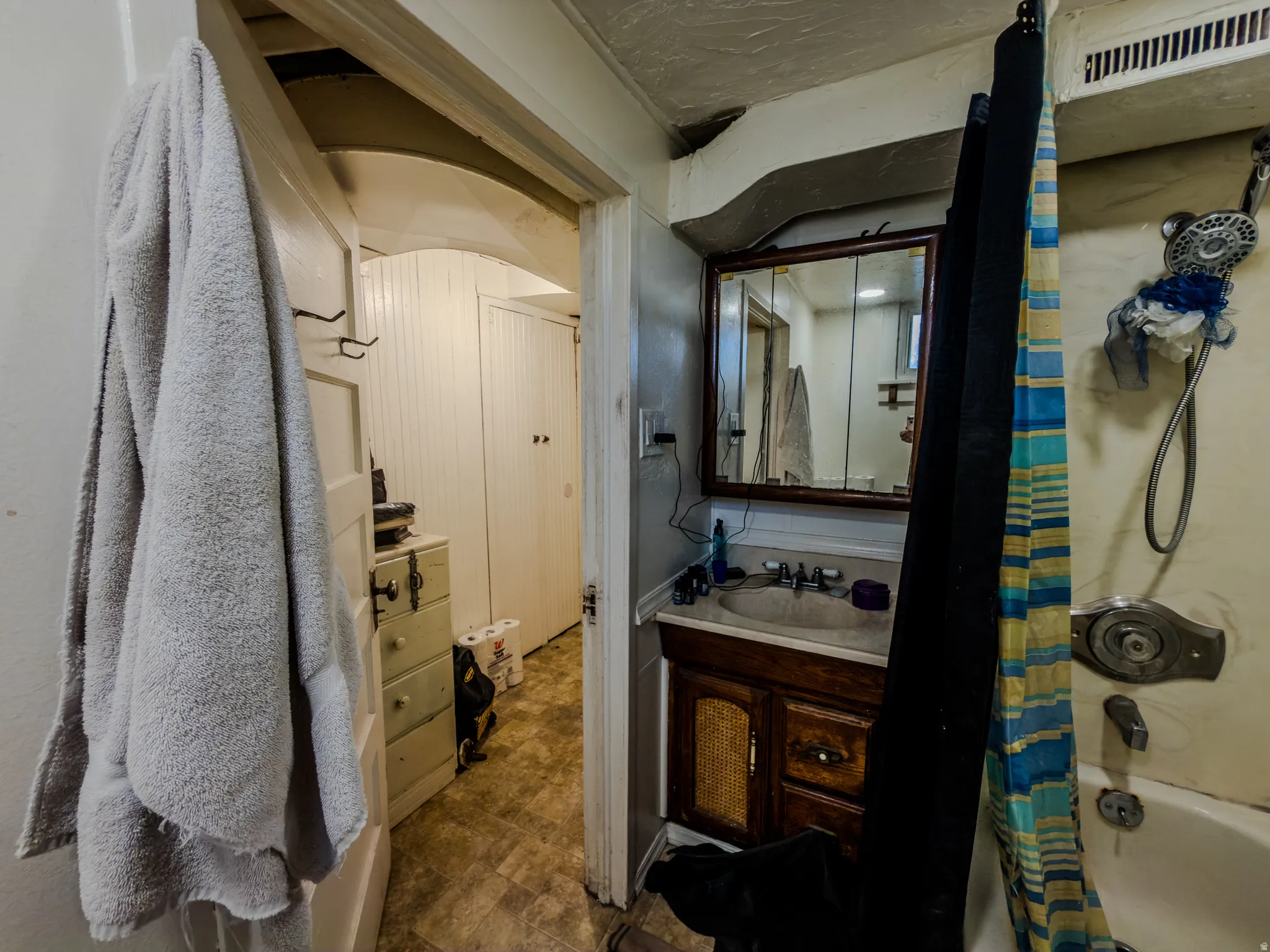 Full bath featuring vanity and shower / tub combo with curtain
