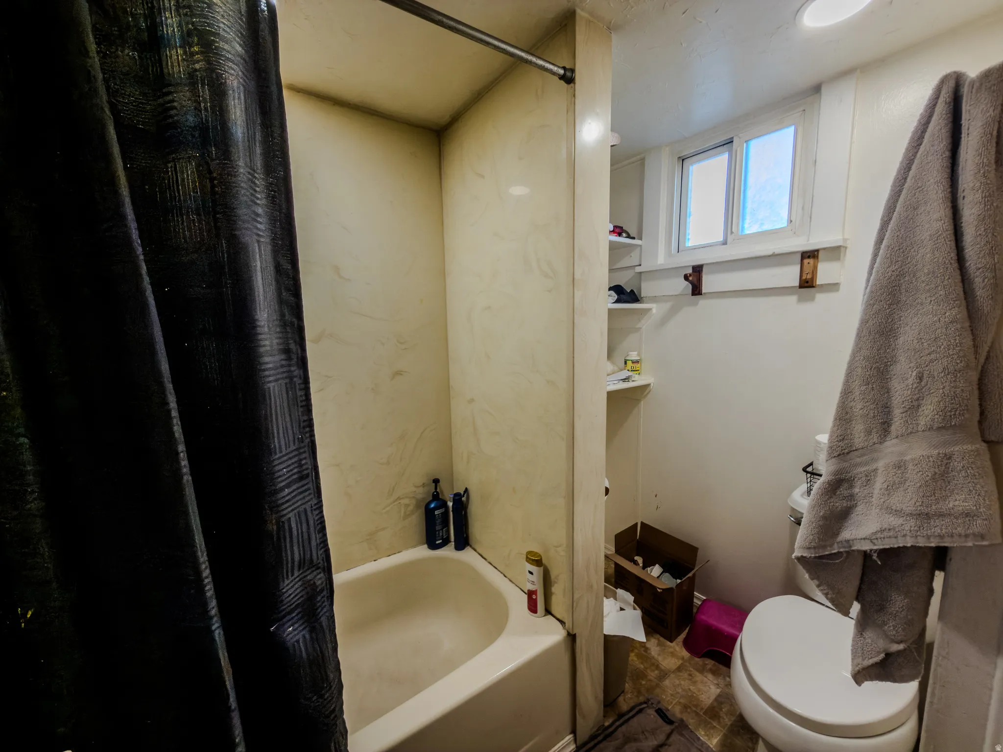 Full bathroom with toilet and shower / tub combo with curtain