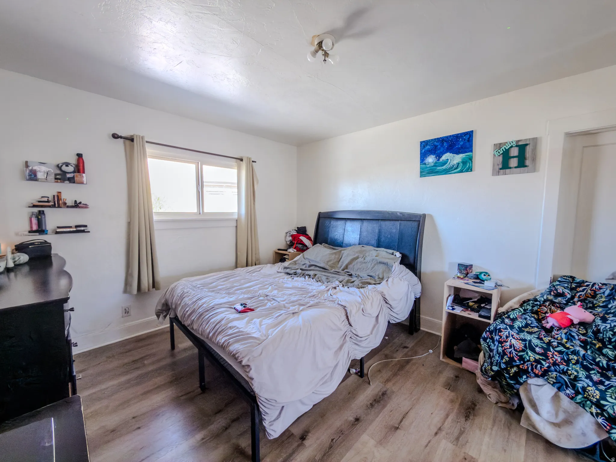 Bedroom featuring wood finished floors and baseboards