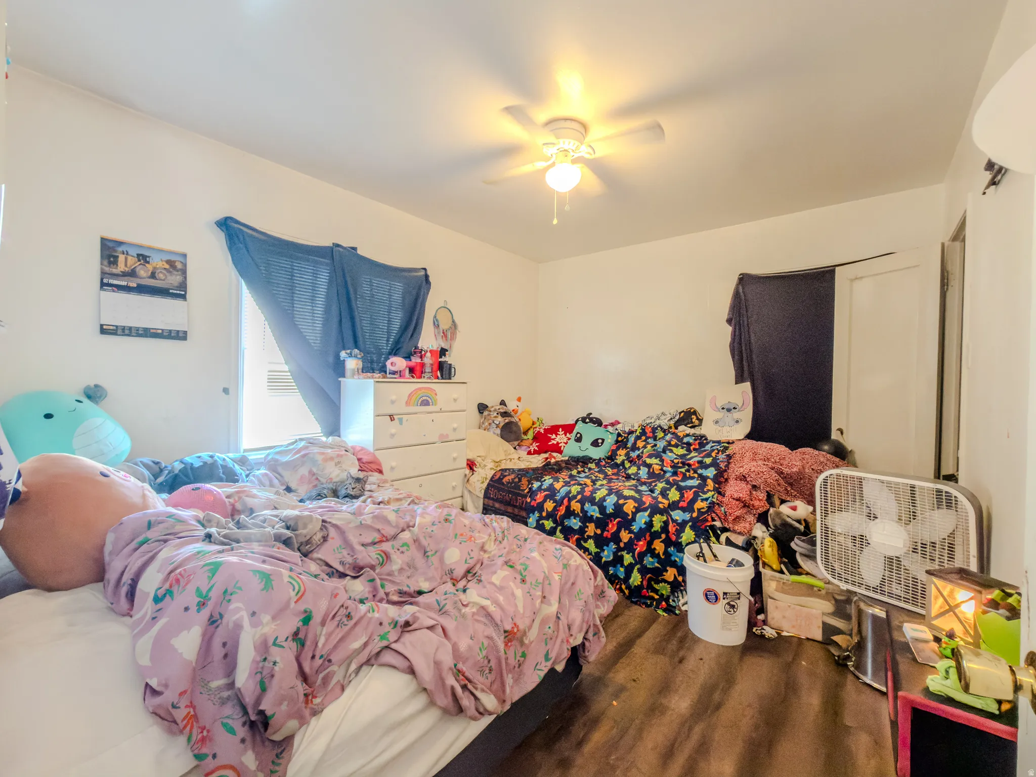 Bedroom featuring dark wood-type flooring and ceiling fan