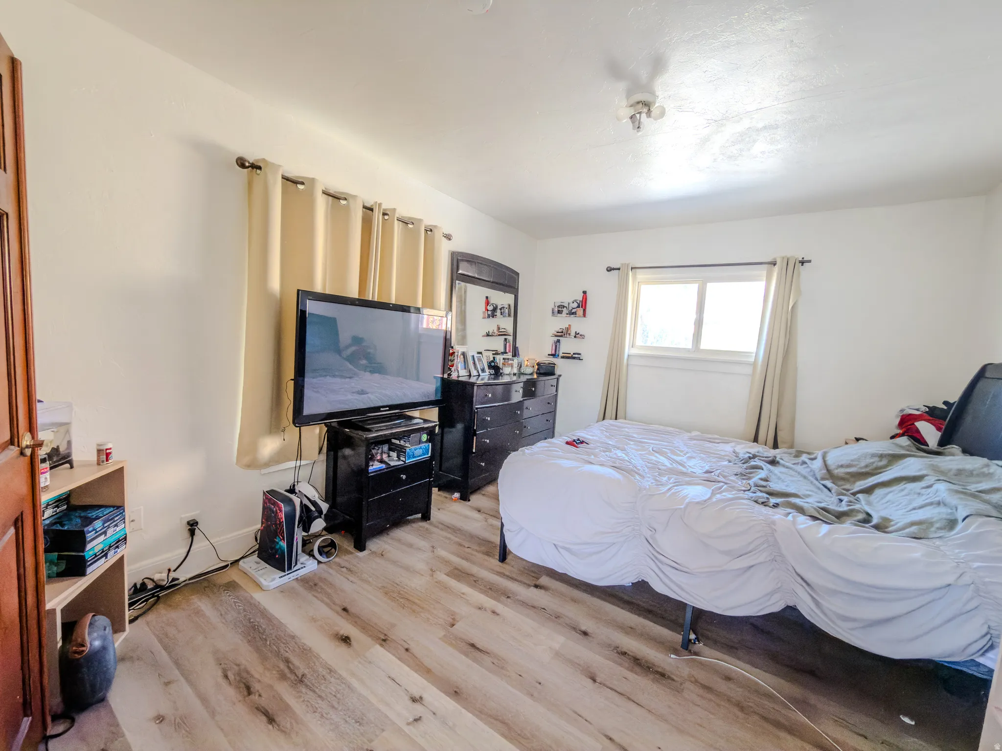 Bedroom with light wood-style flooring and baseboards