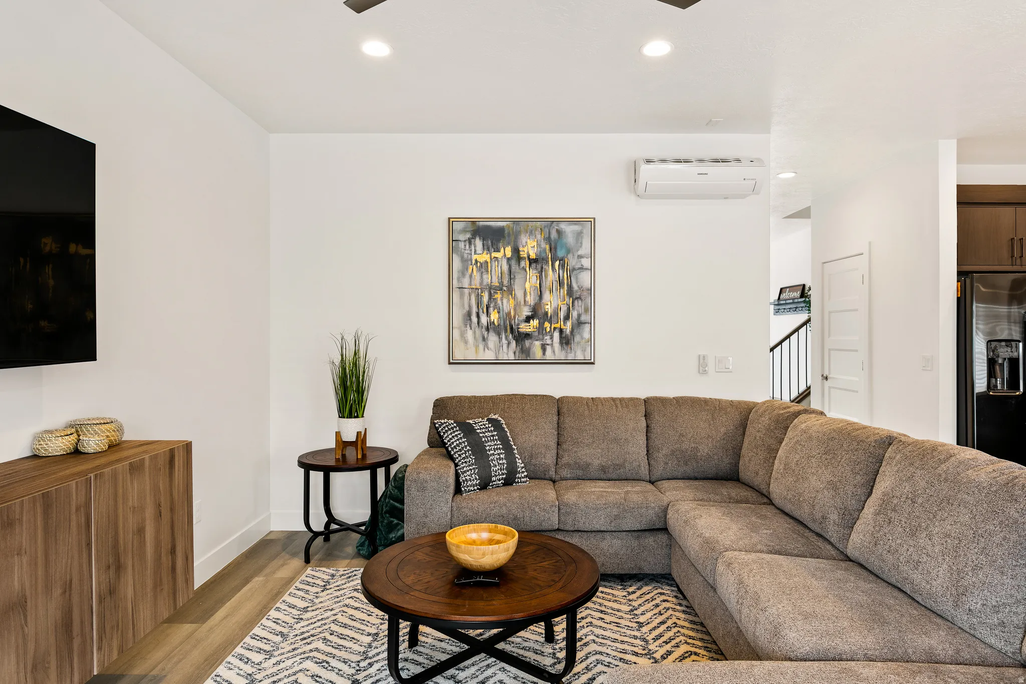 Living area featuring wood finished floors, recessed lighting, and a ceiling fan