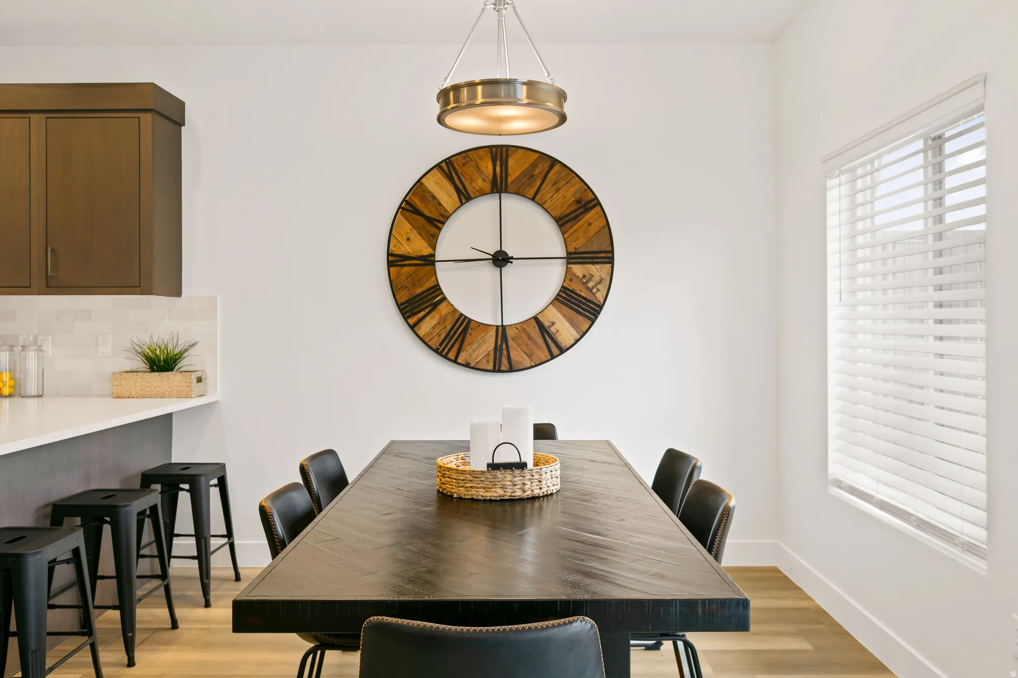 Dining room featuring light wood-style flooring and baseboards