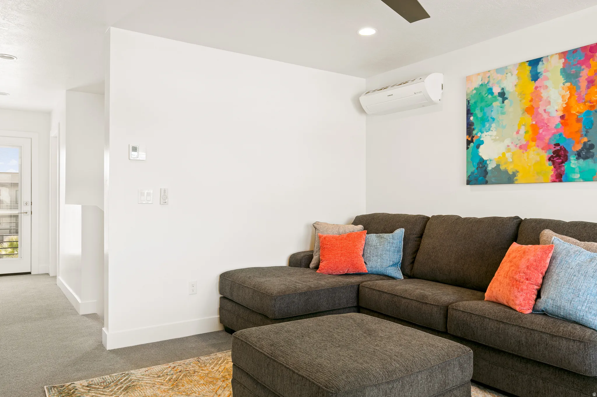 Living area with carpet flooring, recessed lighting, and ceiling fan