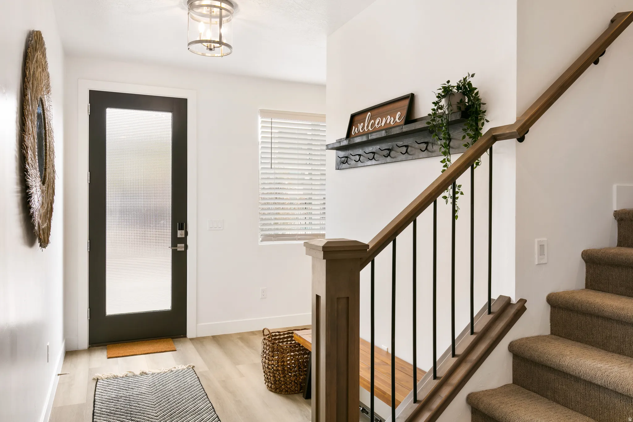 Entrance foyer with stairs and light wood finished floors