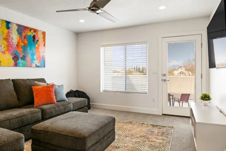 Living area featuring ceiling fan, light carpet, and recessed lighting