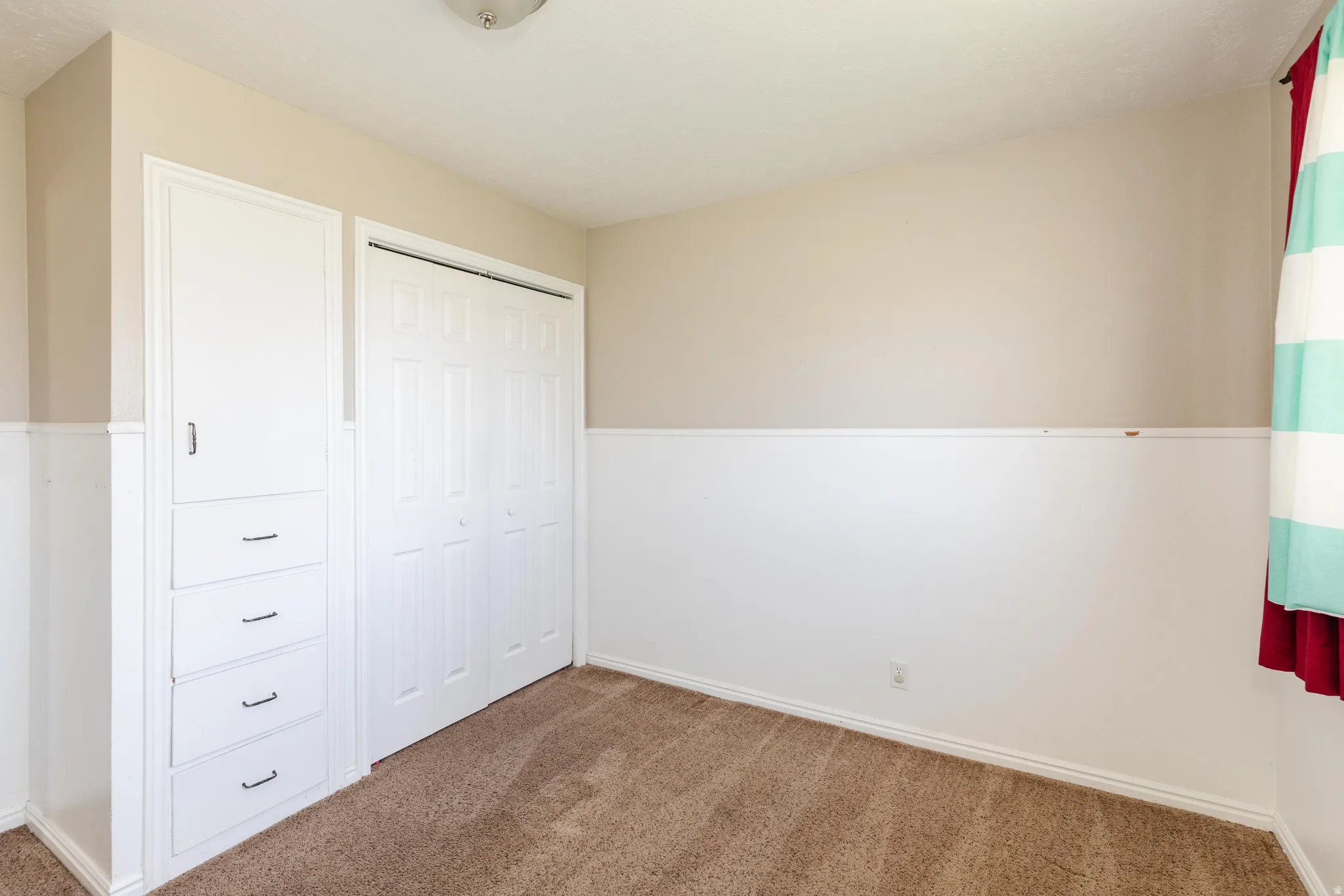 Unfurnished bedroom with carpet and a closet