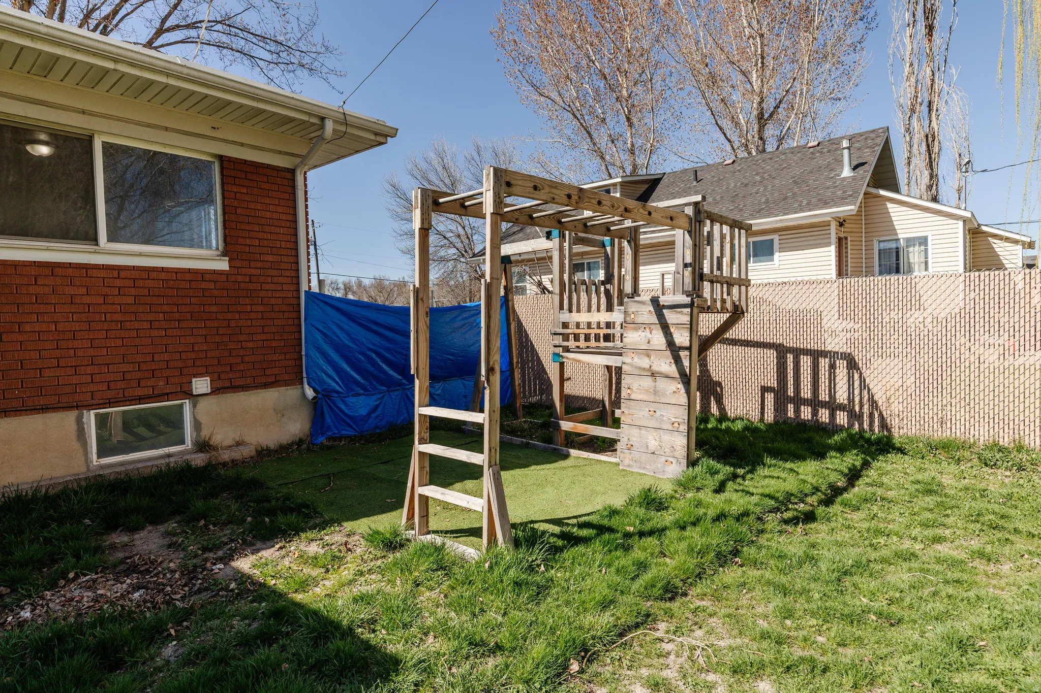 Fenced backyard featuring a pergola